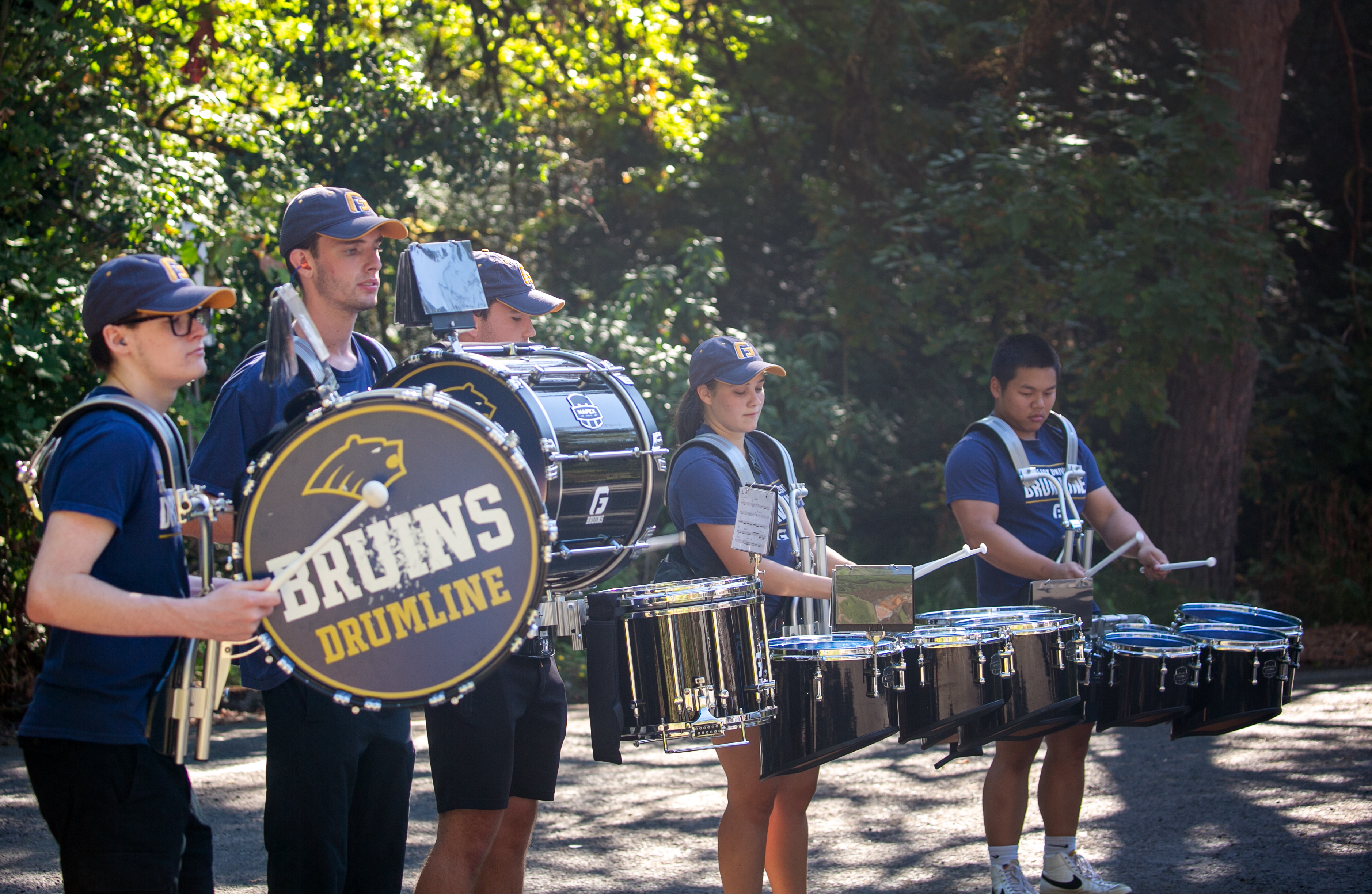 The George Fox University drummers play outside of dorms.