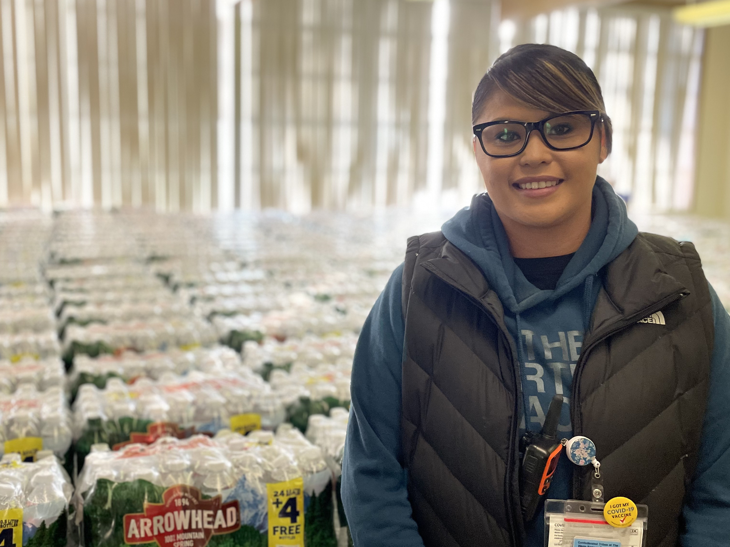 Dot Thurby with some of the thousands of water bottles the Confederated Tribes of Warm Springs distributes to members every day.