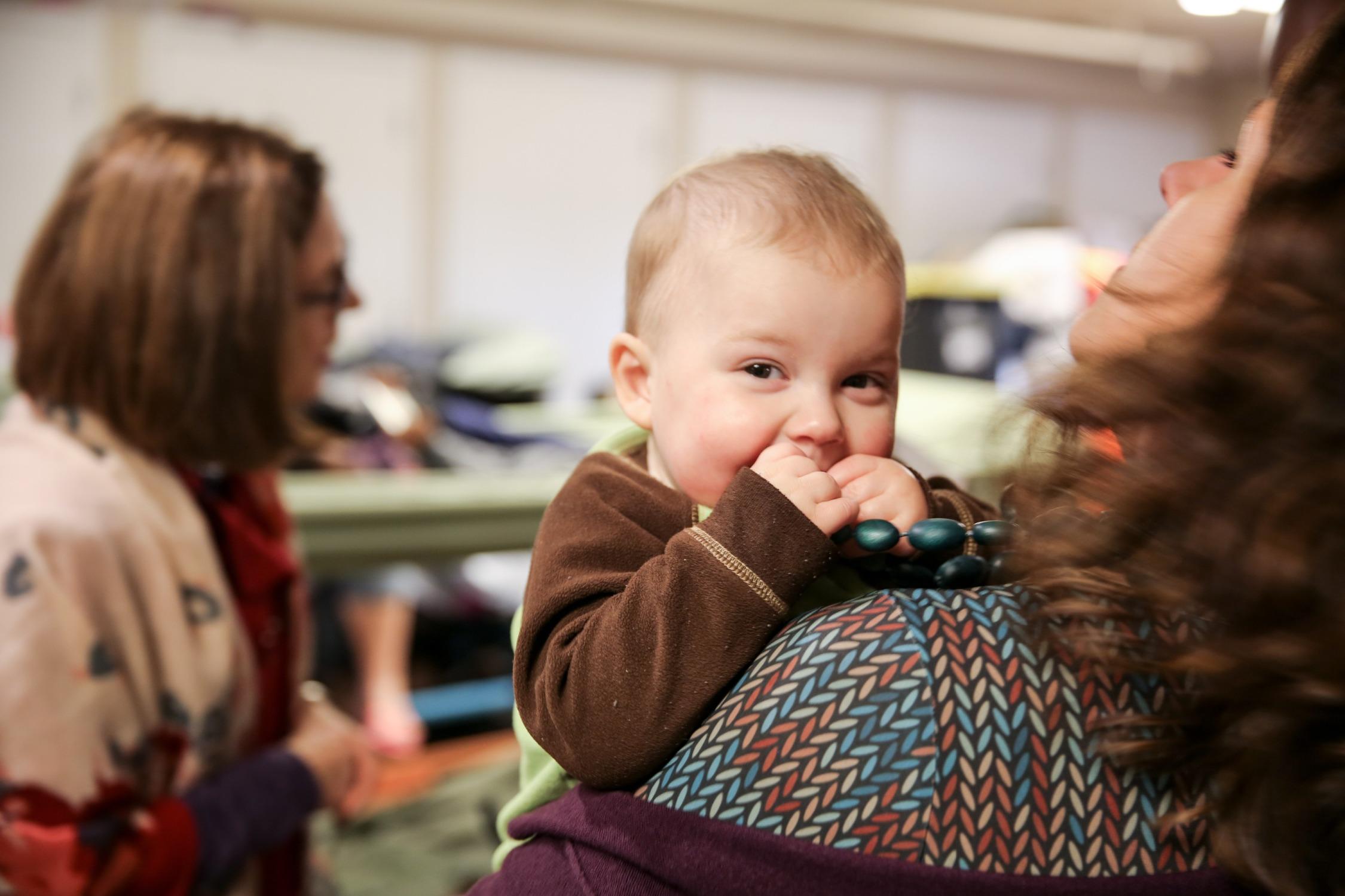 Multnomah County Chair Deborah Kafoury holds an infant at the Human Solutions family shelter. The county attempted to guarantee a bed for every homeless child, but reversed course. 