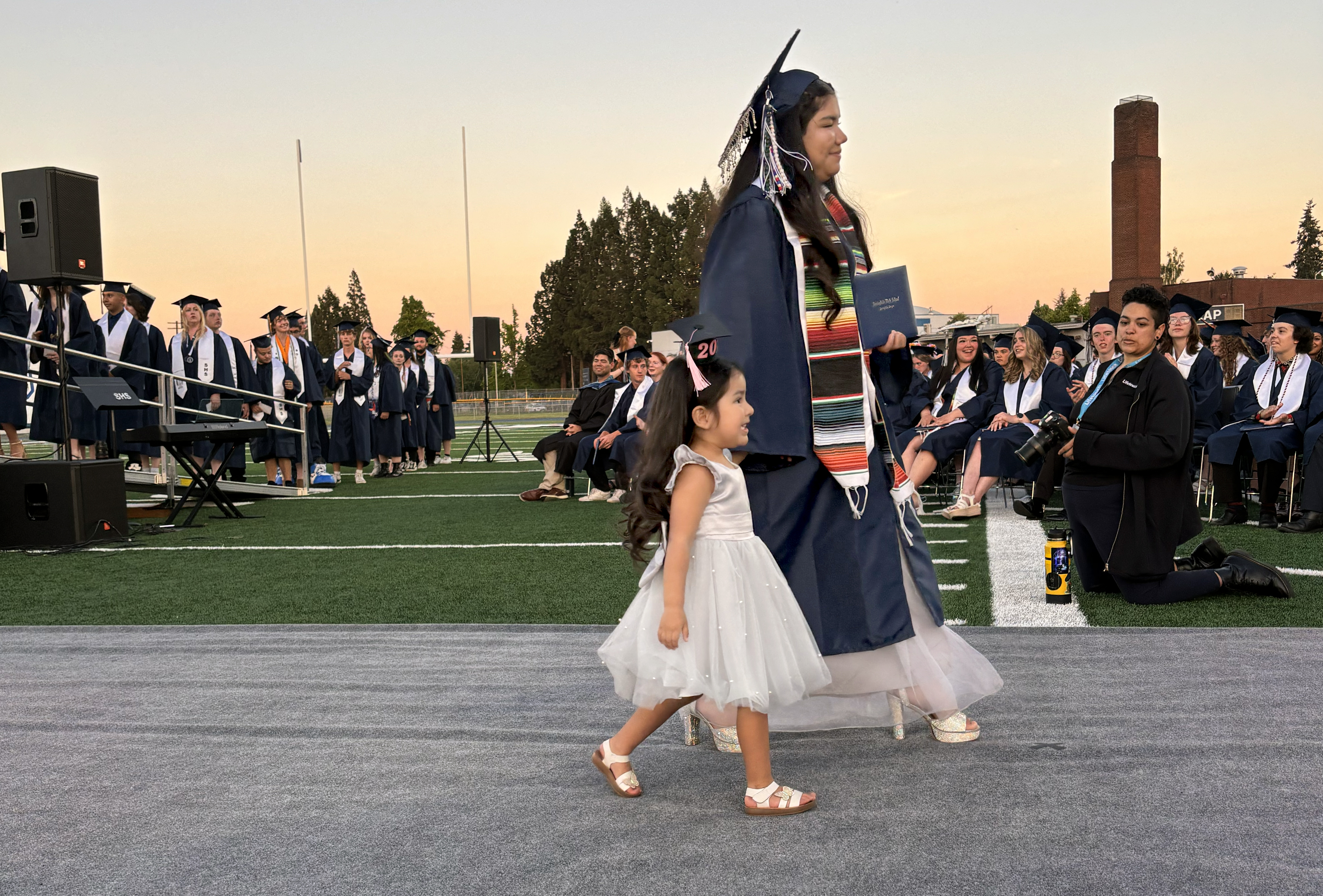 A graduate of Springfield High School descends from the commencement stage on June 5, 2025. The bilingual, bicultural celebration attracted friends and family members of all ages.
