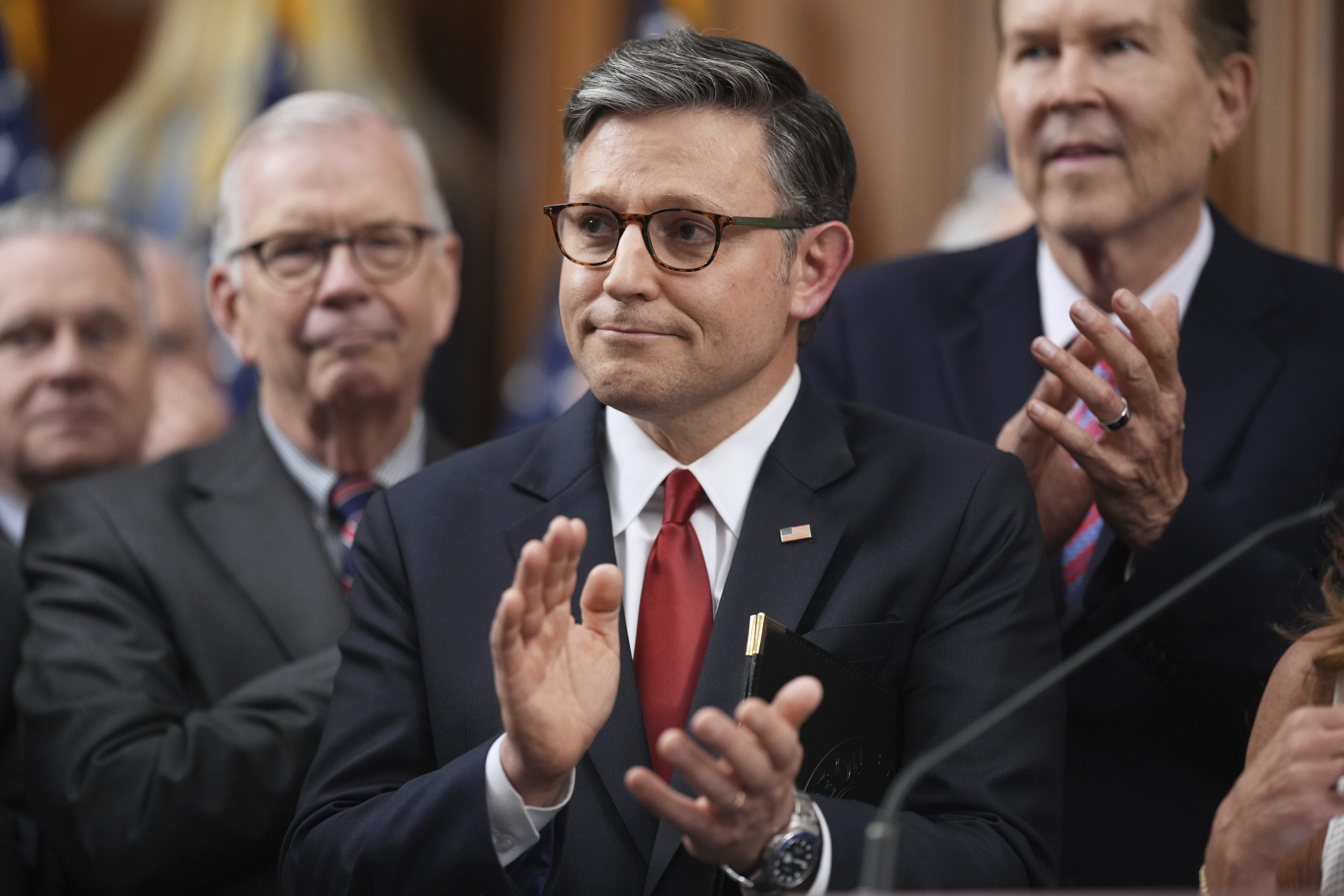 Speaker of the House Mike Johnson, R-La., is seen with other Republican House members after the passage of President Donald Trump's signature bill of tax breaks and spending cuts, at the Capitol in Washington, Thursday, July 3, 2025.