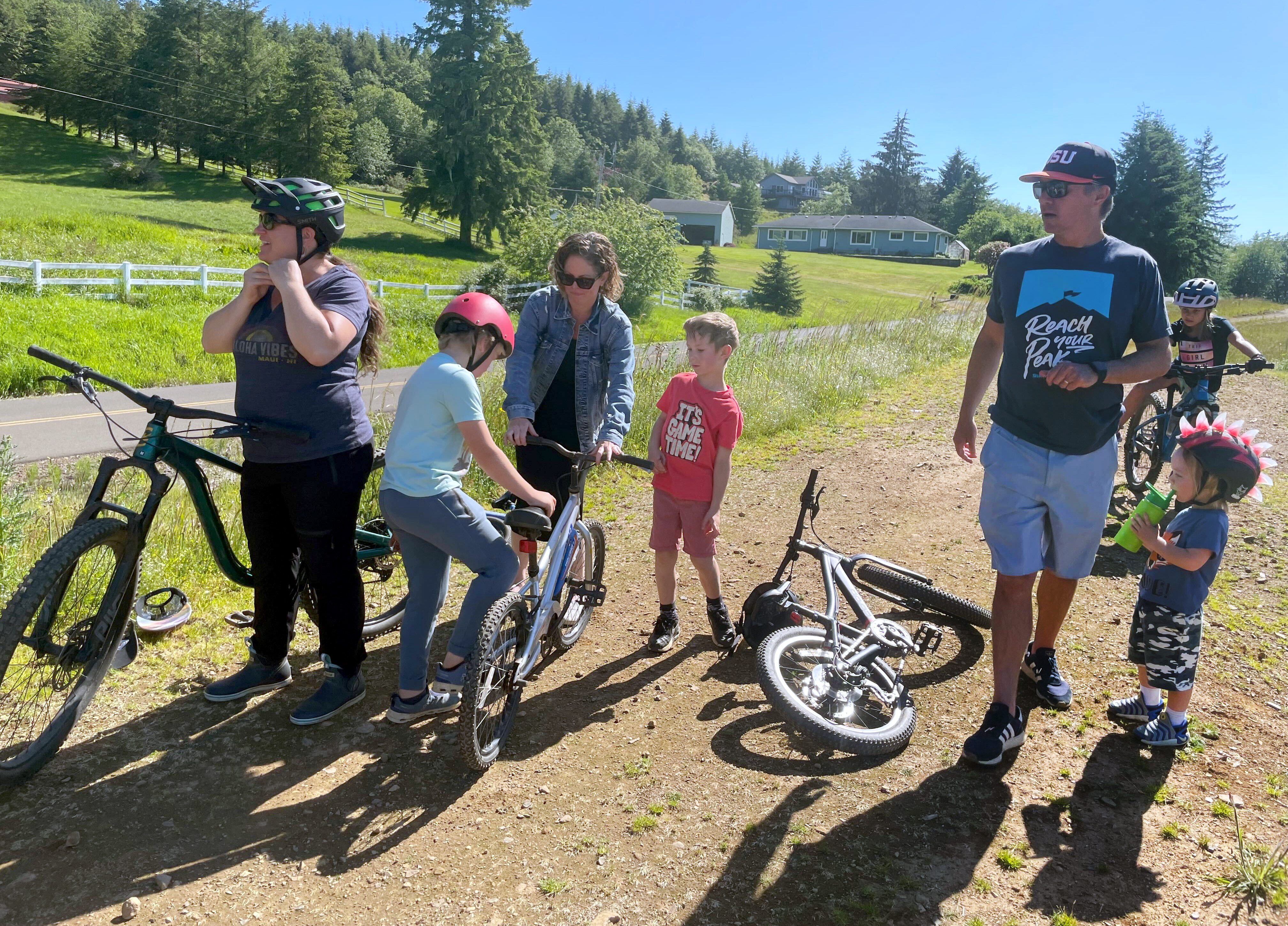 Members of the Tillamook Off-road Trail Alliance gear up to ride mountain bikes on June 7, 2024, behind the Nestucca K-8 School in southern Tillamook County near Cloverdale. The group is trying to build a vast mountain biking system in the nearby Sandlake area. They say they have been working with the U.S. Forest Service for years, developing plans to ensure the system won't ruin the area.