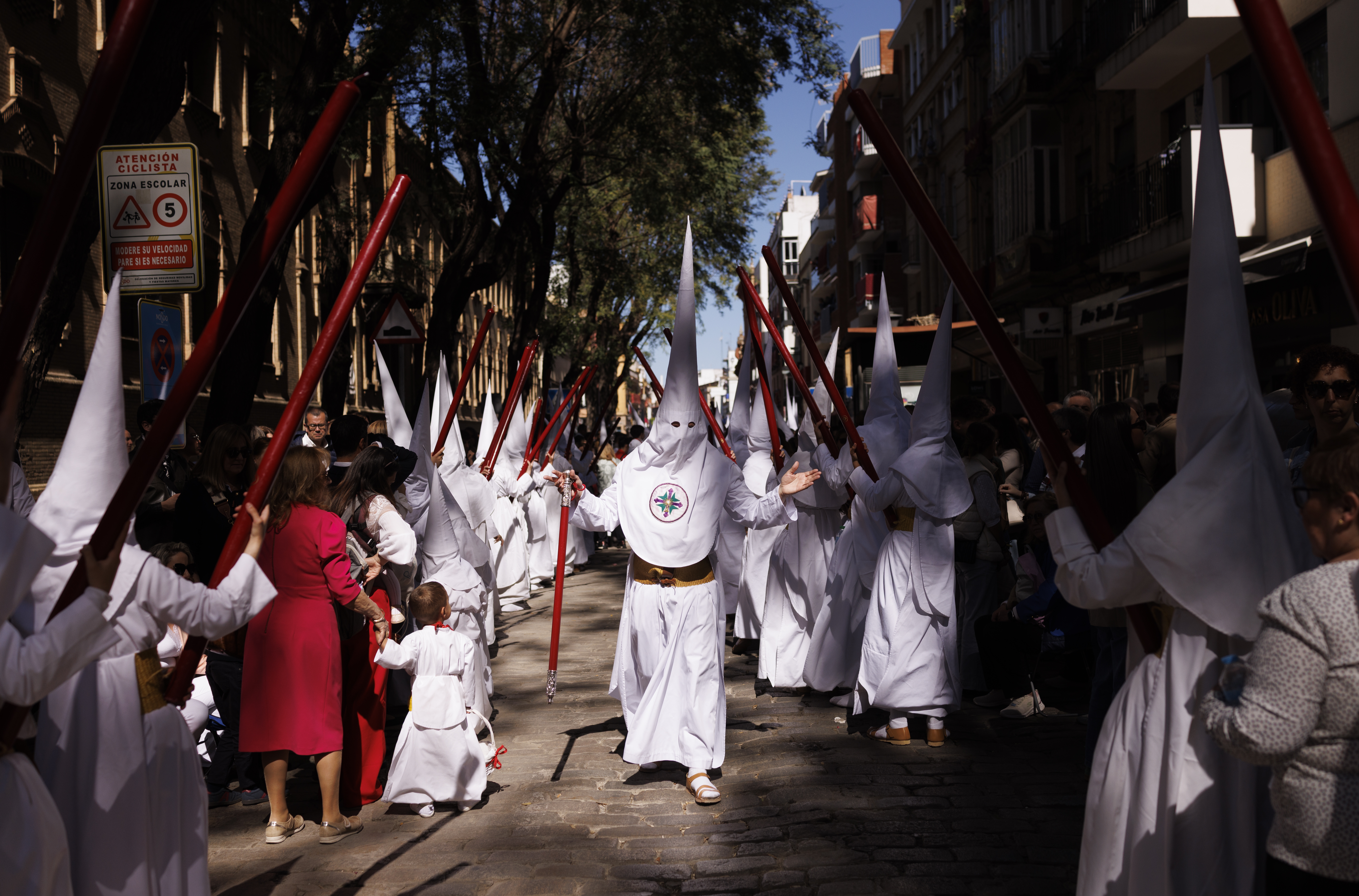 Penitents from the La Paz brotherhood parade in the Palm Sunday procession in Seville