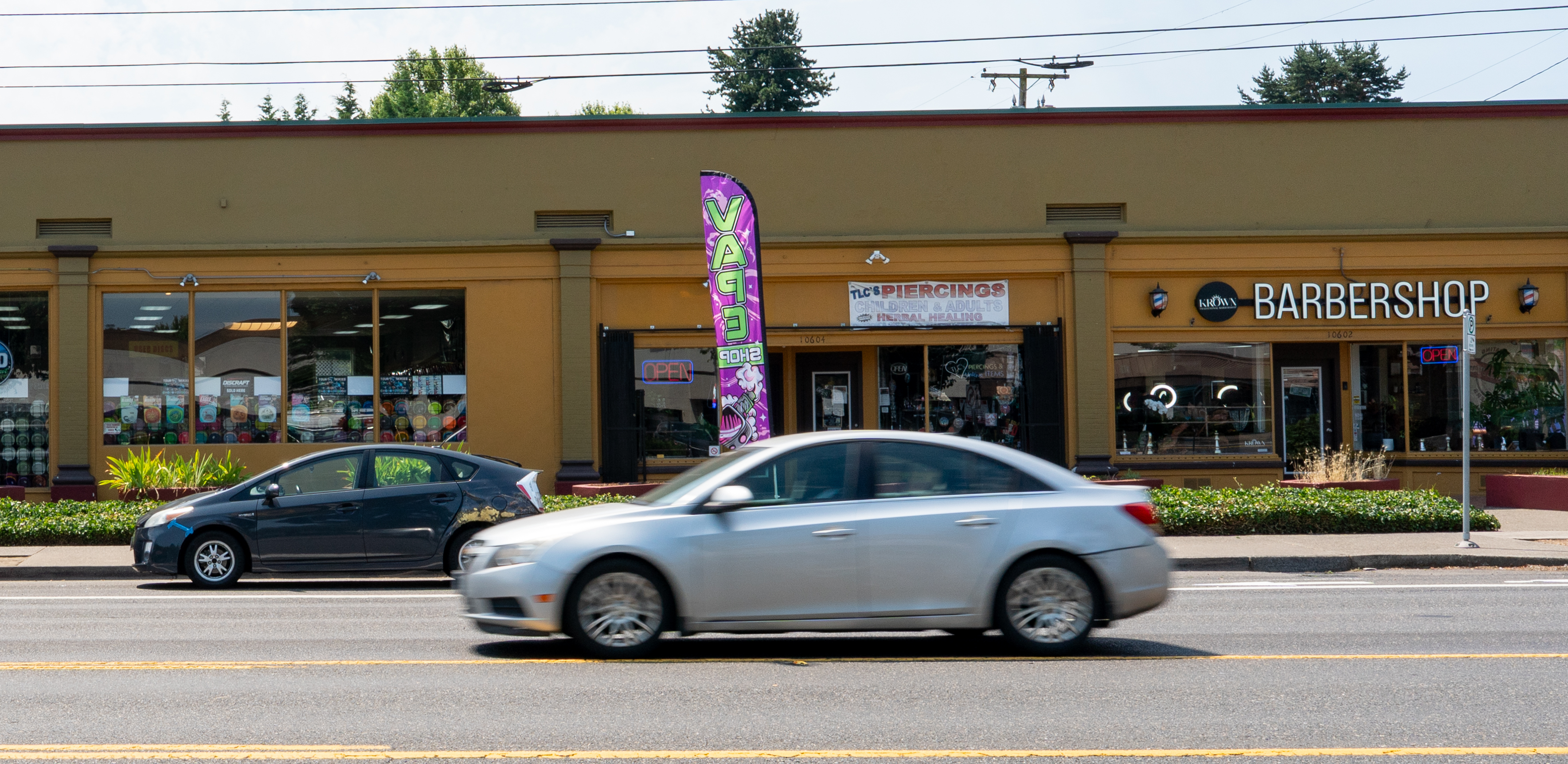 Cars whizz by shops on both sides of Sandy Boulevard, many of which have been in the historic Parkrose neighborhood for years in Portland, Ore., on July 15, 2026.