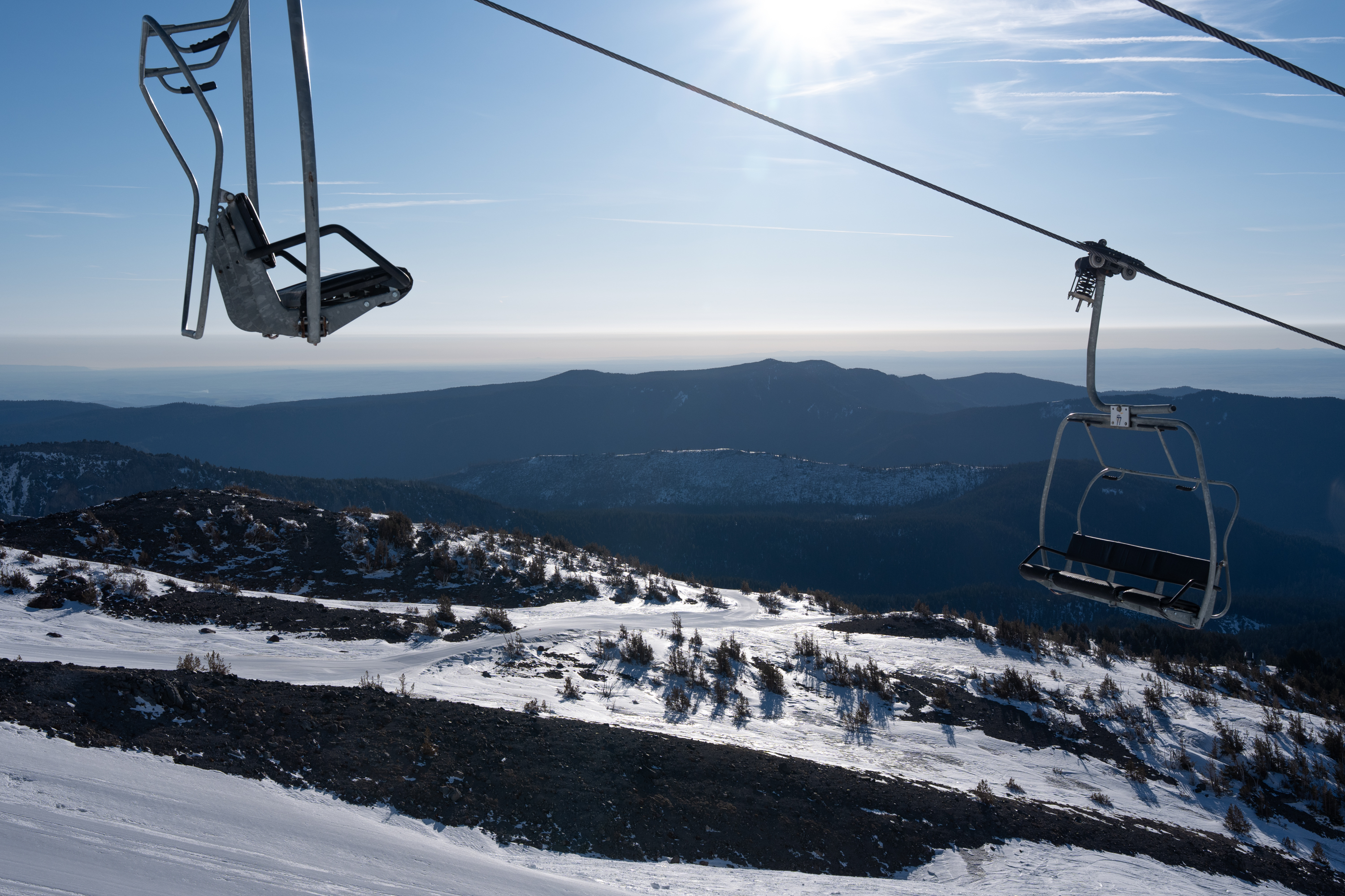 The chair lift sits empty above irregularly patchy snow conditions before Mt. Hood Meadows opens for its second to last weekend in Mount Hood, Ore., on April 4, 2026. The ski resort is closing weeks early this season after an abnormally warm and low snowpack winter.