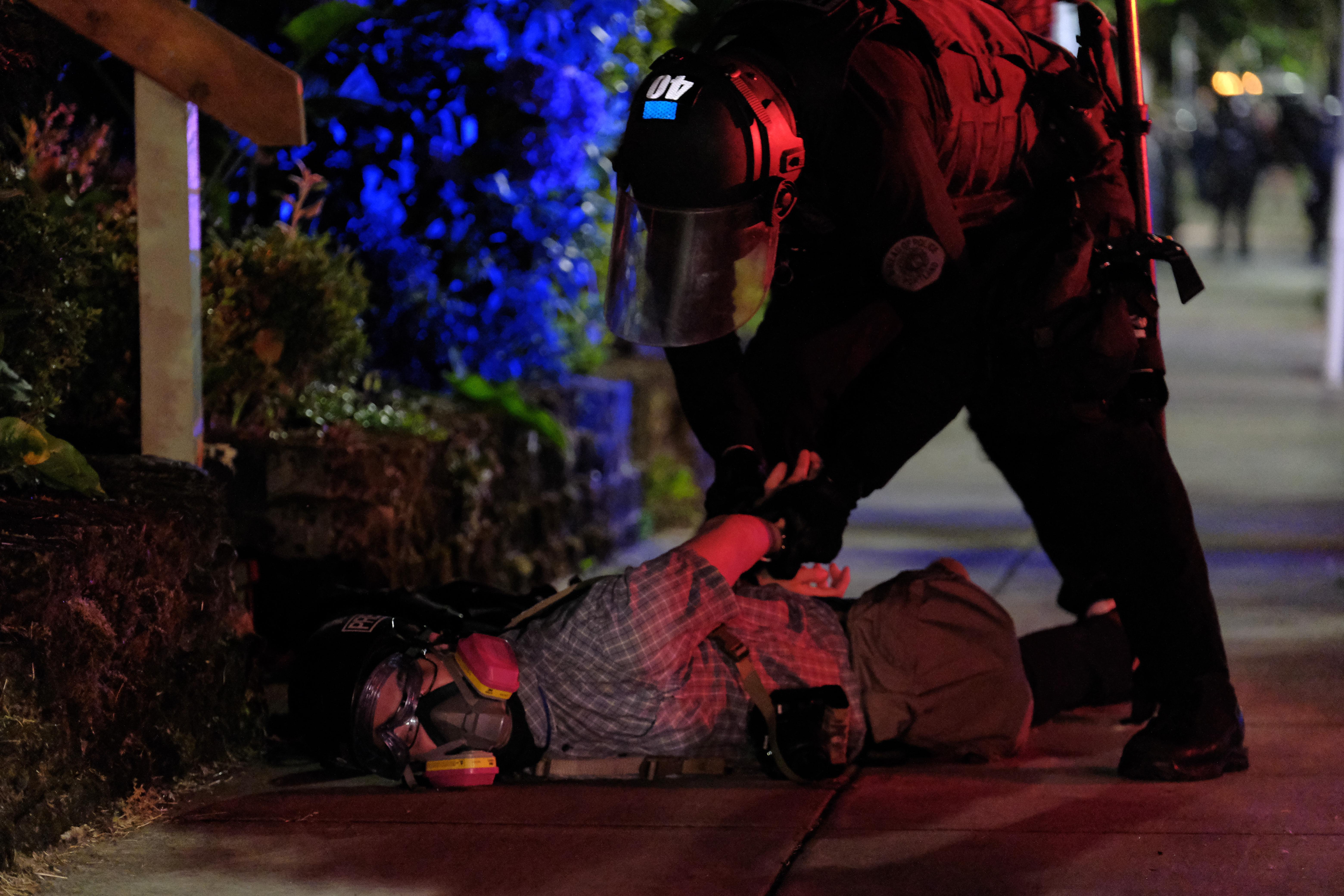 Portland police officers arrested freelance journalist Justin Yau while he reported on a protest June 30, 2020.