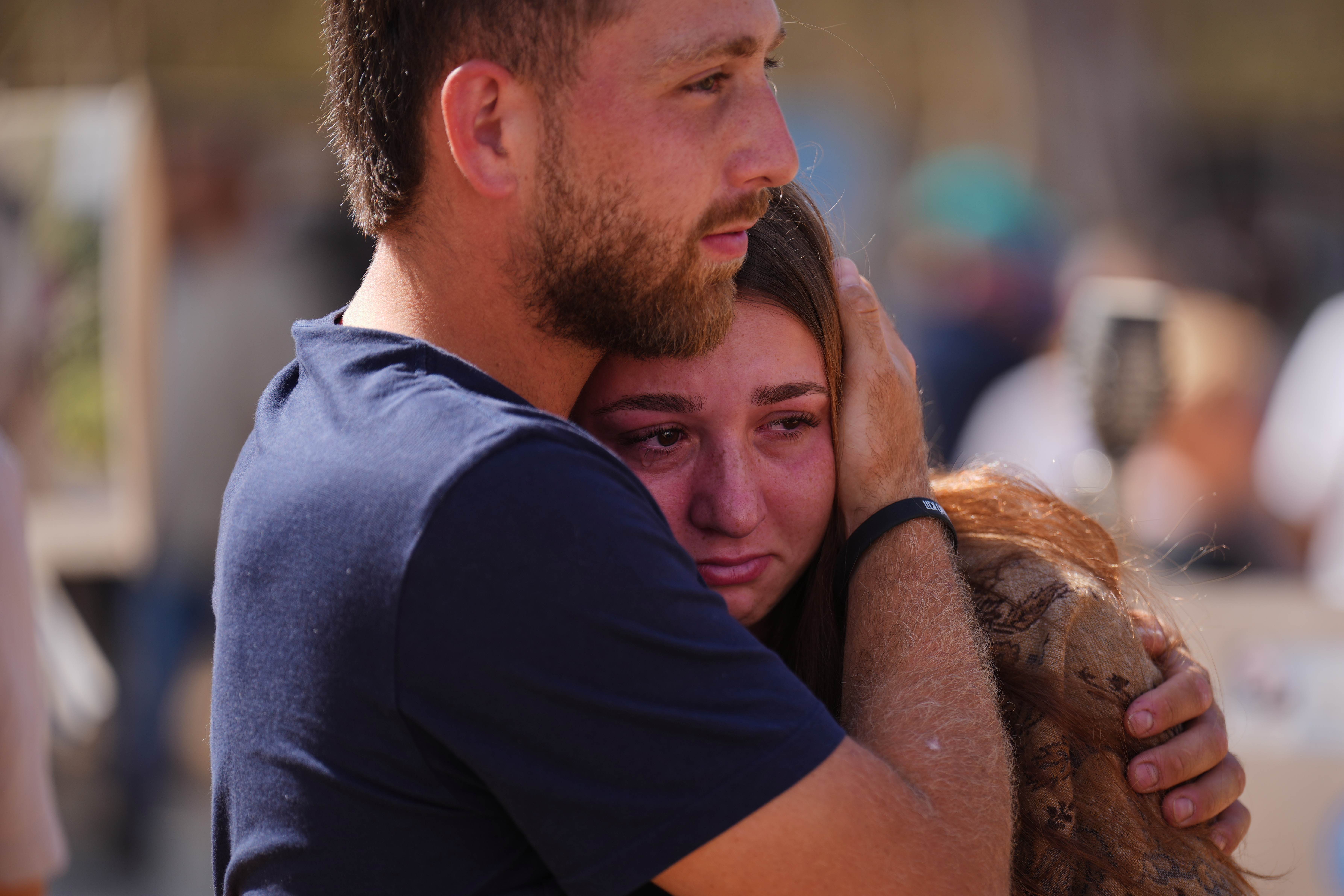 People embrace during a memorial marking two years anniversary of the Oct. 7, 2023 deadly Hamas attack on Israel, at the site of the Nova music festival near Kibbutz Reim in southern Israel, where hundreds of revelers were killed and abducted in the assault, Tuesday, Oct. 7, 2025.