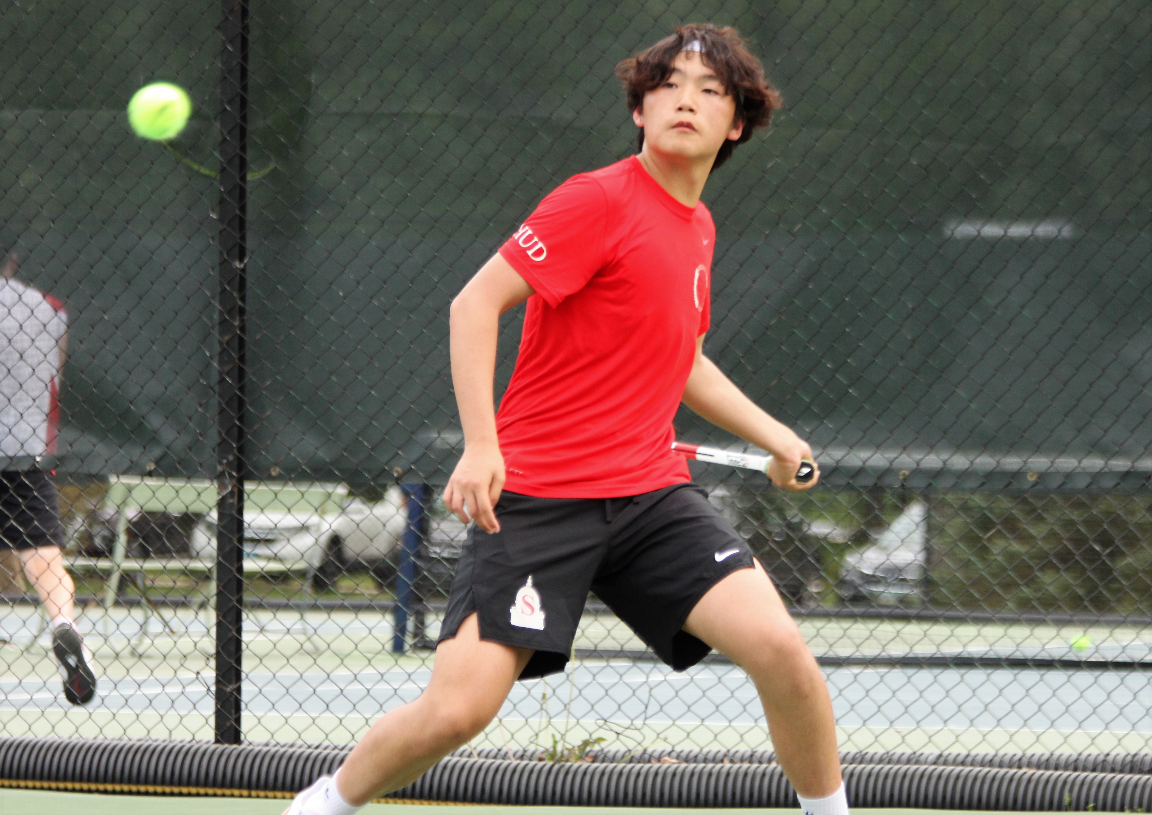 Springfield (Ill.) High School's David Lu returns a shot during a tennis tournament in May. When it's not attacking Democrats, the partisan Sangamon Sun has written repeatedly about Lu's national ranking - recently at 7,379th for boys under 18 - with no additional information. The paper twice illustrated the articles with a photo of a boy who appeared to be no older than 10, and white.