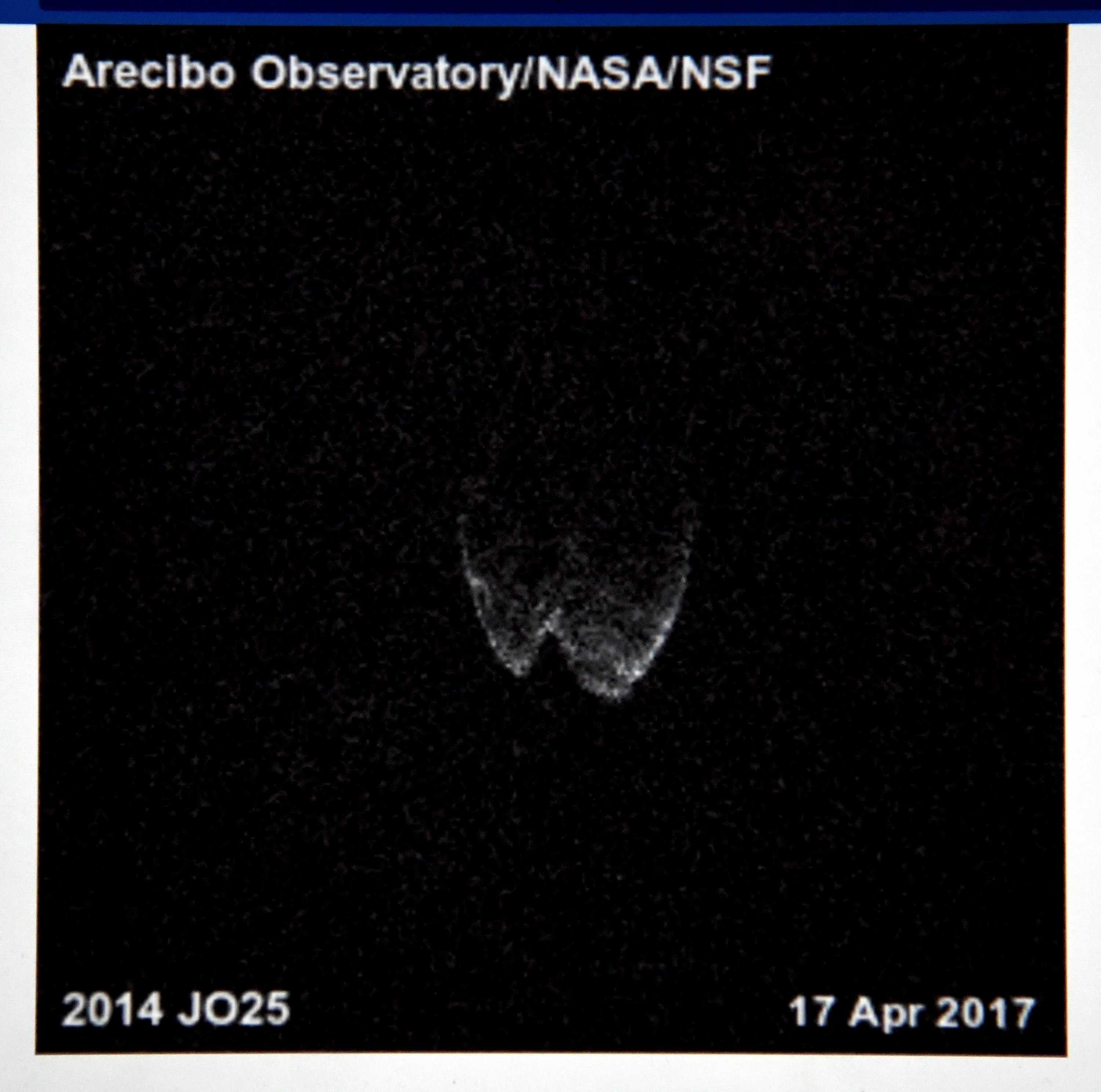 A radar image of asteroid 2014 JO25 from a radio telescope at the Arecibo Observatory/NASA/NSF in Puerto Rico taken on April 17, 2017, is shown on a screen by a member of the Las Vegas Astronomical Society outside the Planetarium at the College of Southern Nevada on April 19, 2017, in North Las Vegas, Nev.