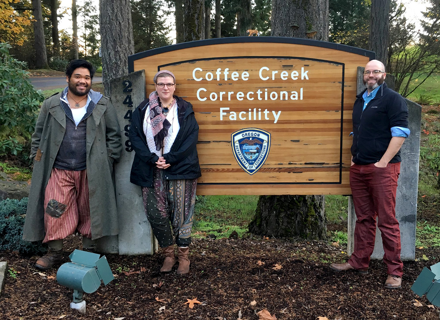 (Left to right) Paul Susi, composer/cellist Anna Fritz, and director Patrick Walsh in front of the Coffee Creek Correctional Facility in Wilsonville, Ore., where Susi performed in 2018.