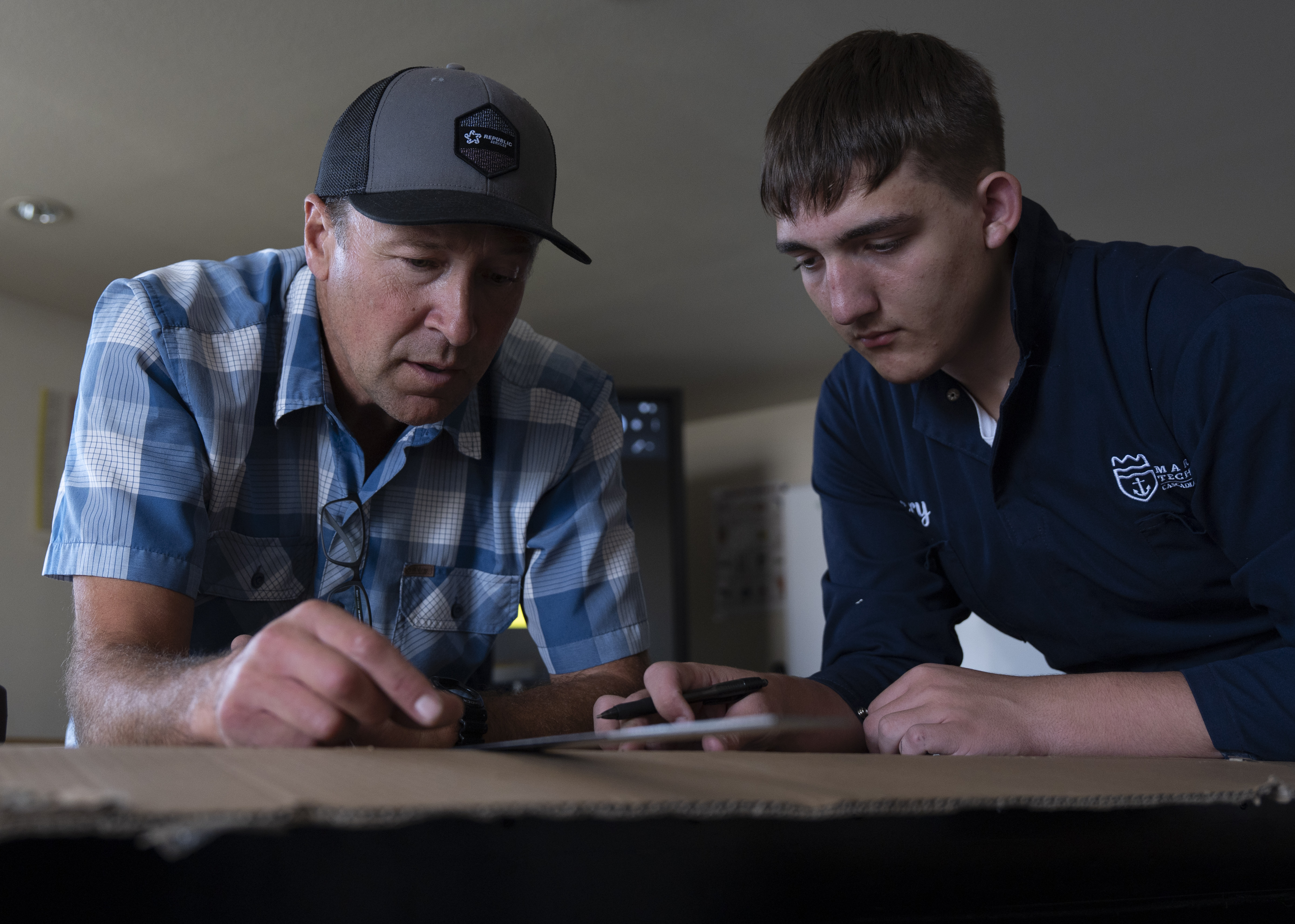 Maritime Technology instructor Colton Edmiston, left, helps first-year student Noah Williamson in Vancouver, Wash., on Aug. 27, 2026. The students are building to-scale models of an 800-foot tanker as part of the program.