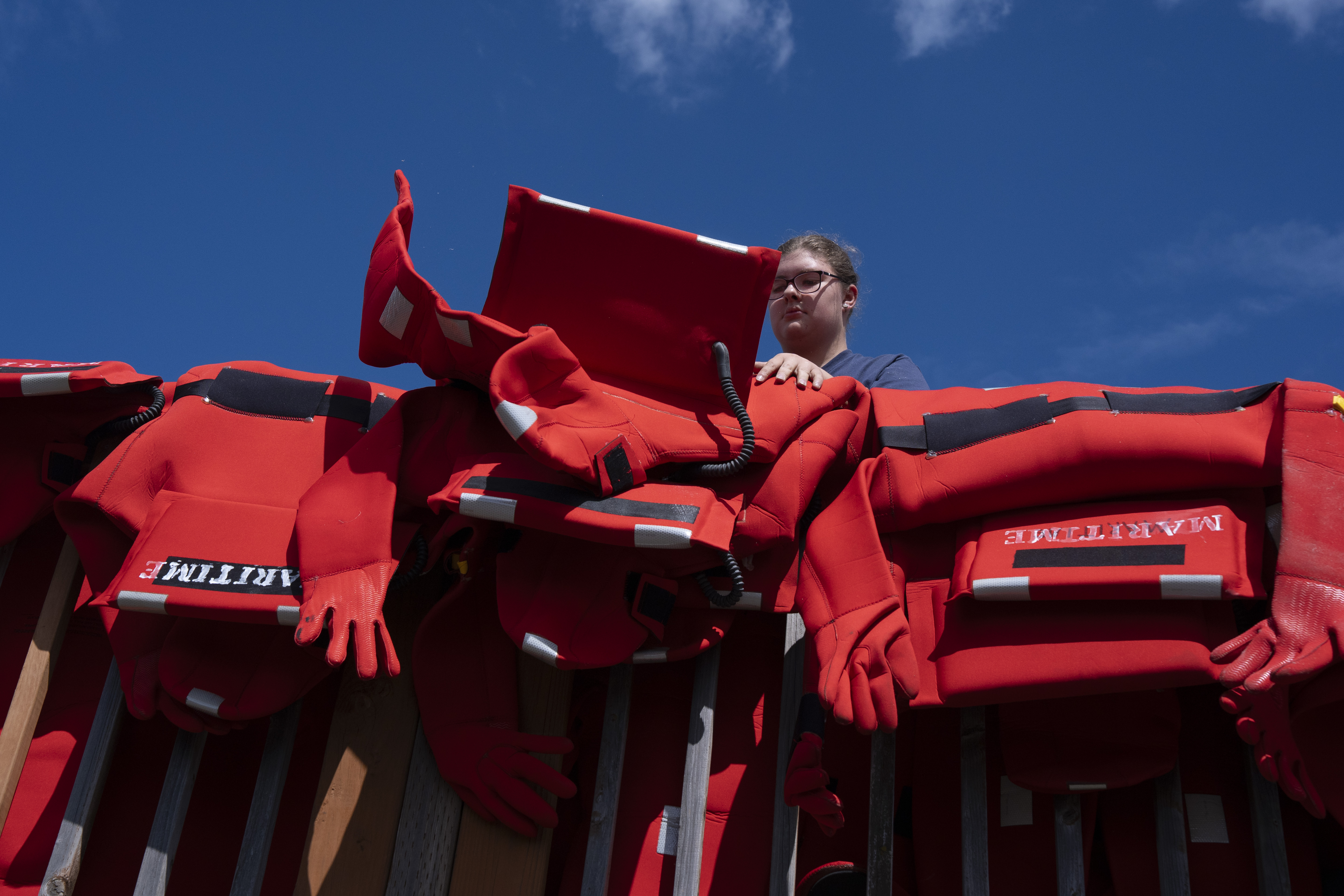 Student Annabelle Corpuz hangs up equipment.