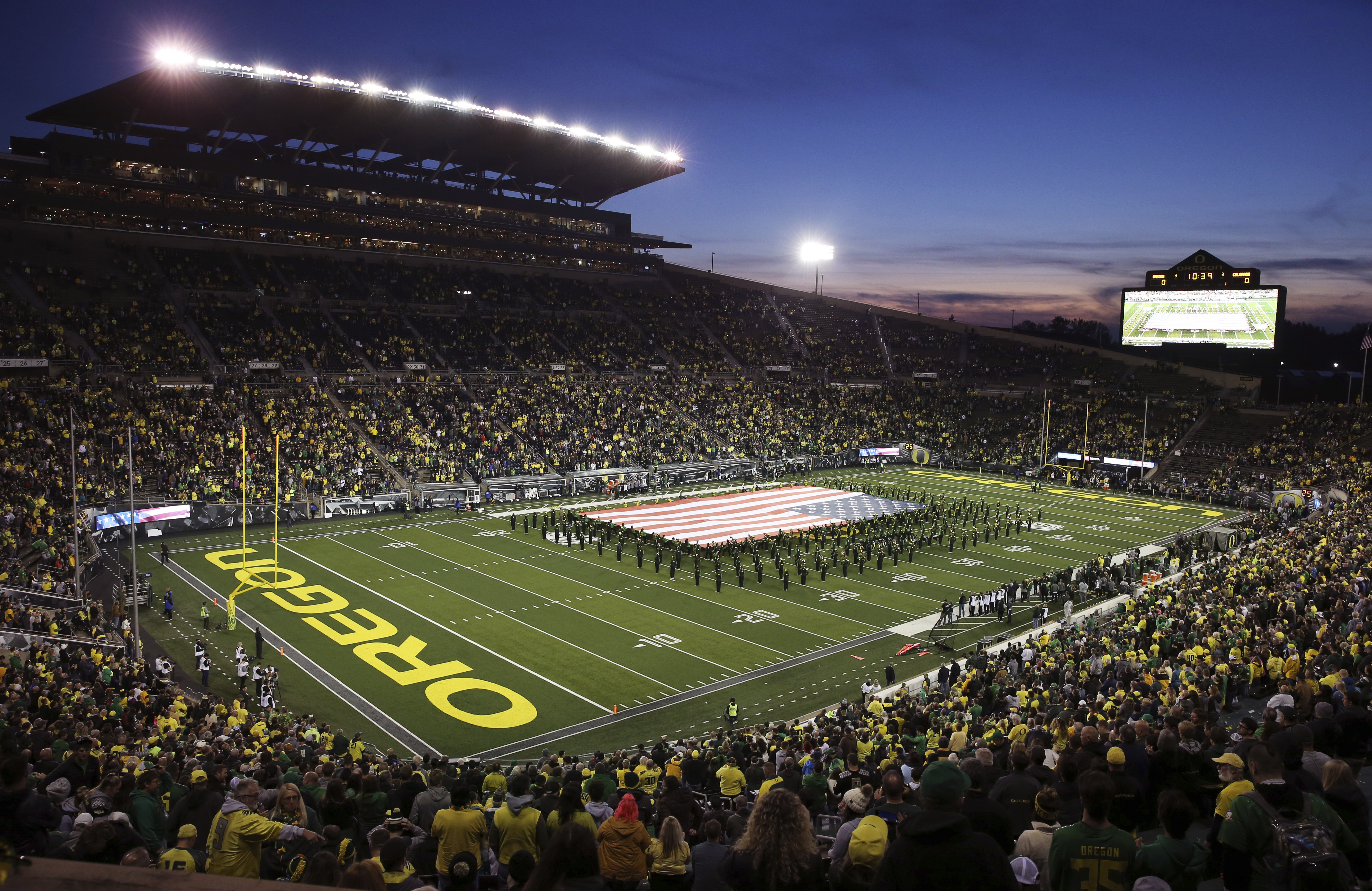 FILE: The Oregon Marching Band displays a giant United States flag on the field at Autzen Stadium before a football game against Colorado, Oct. 11, 2019, in Eugene, Ore.