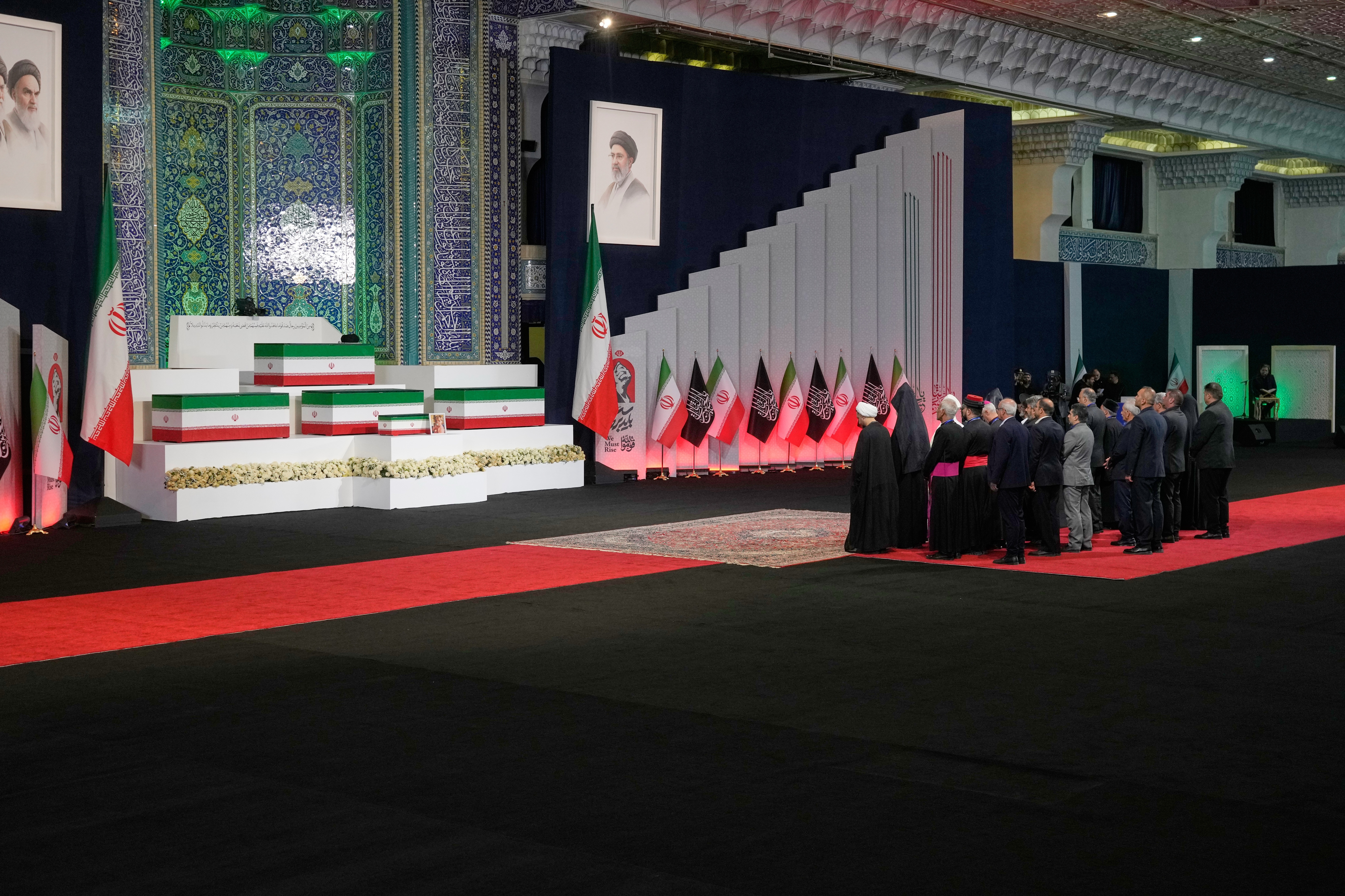 Iranian religious leaders and other mourners pay their respects before the coffins of slain Iranian Supreme Leader Ayatollah Ali Khamenei and members of his family during a viewing ceremony ahead of the dayslong funeral ceremonies at the Imam Khomeini Mosalla Grand Mosque in Tehran, Iran, Friday, July 3, 2026.