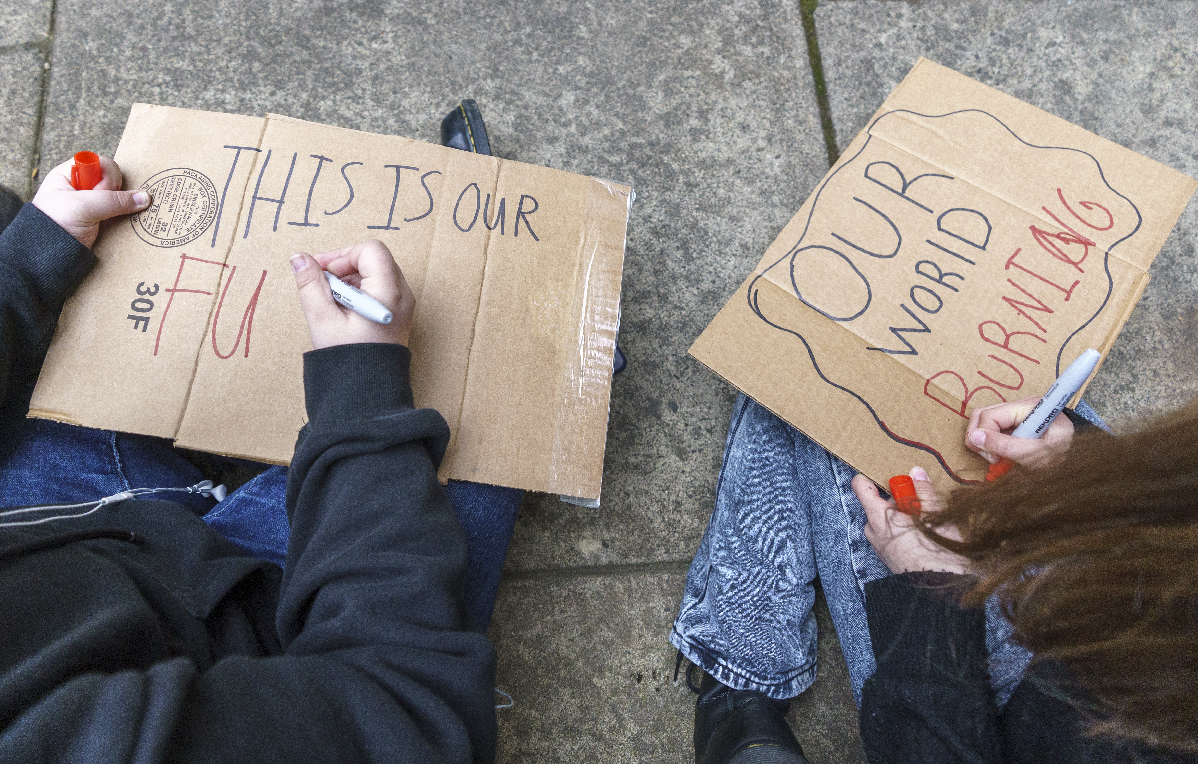 FILE - Youth climate activists make signs for a rally in downtown Portland, May 20, 2022.