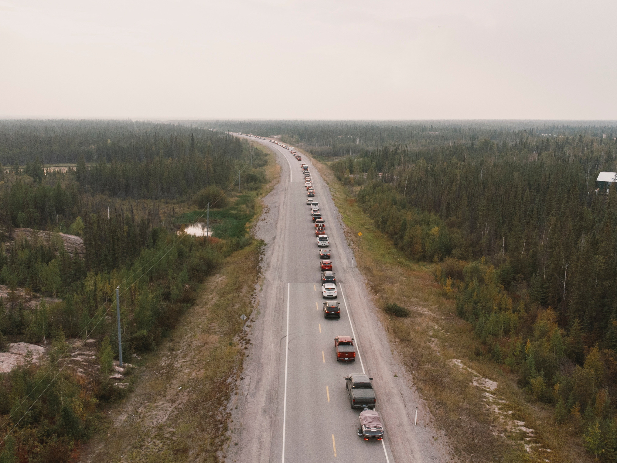 Residentss flee Yellowknife on Highway 3 after being ordered to evacuate on Wednesday due to a wildfire heading closer to the city.