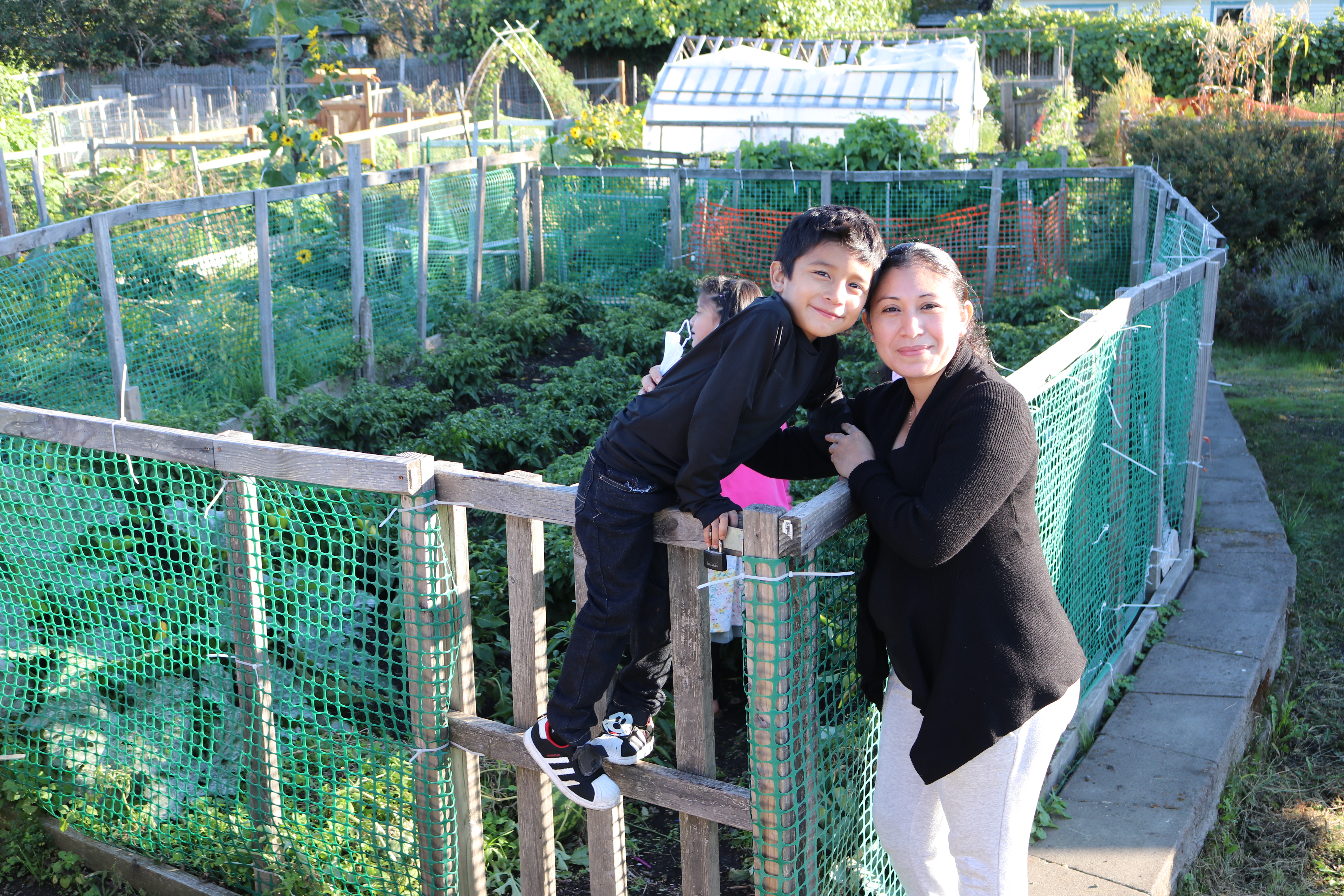 Wendi Suni Yah Canul and her son Mario Valle Yah (6) pose in front of their community garden plot located in Northeast Portland's Cully Park on Oct. 7, 2021.