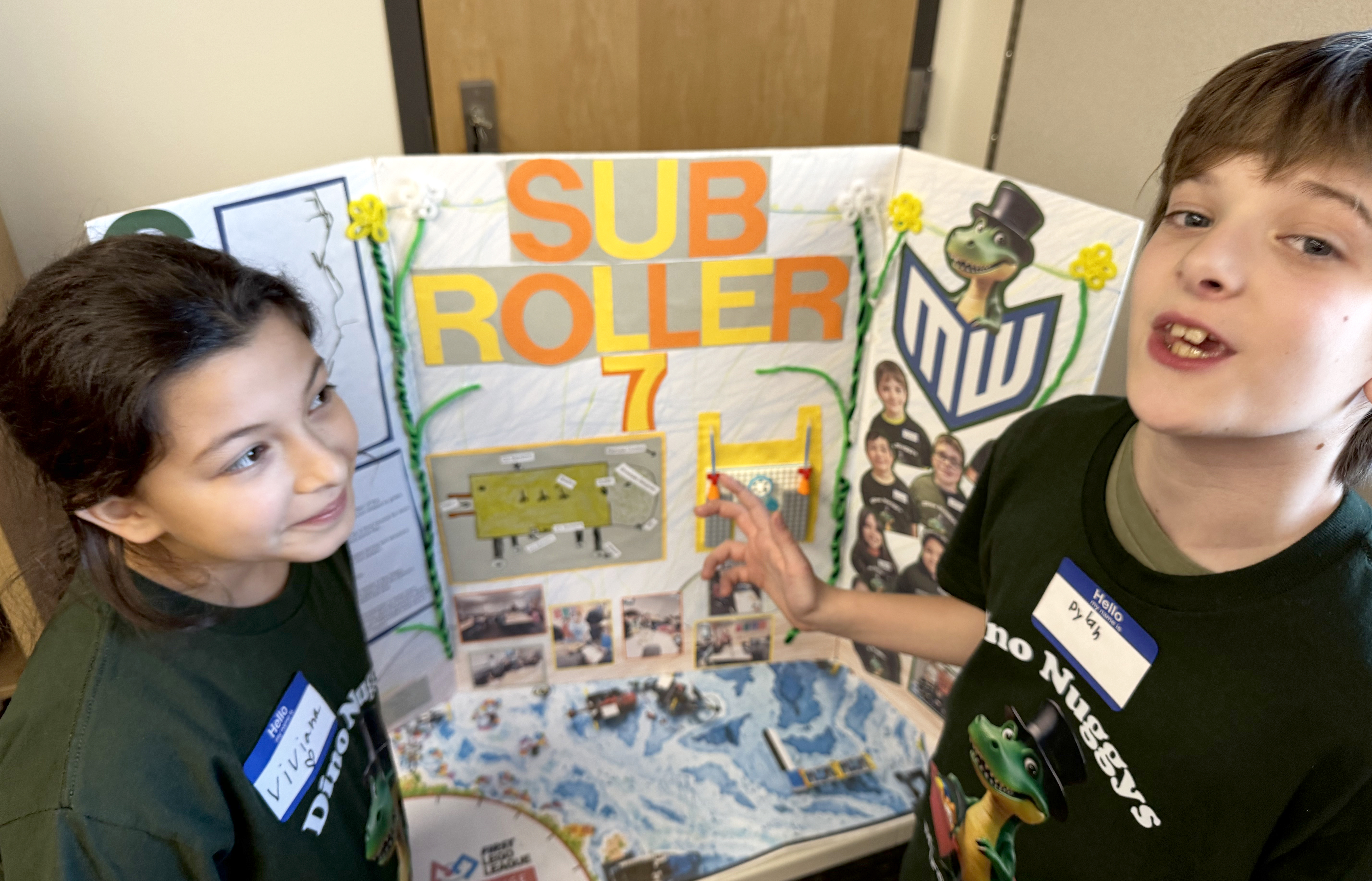 Fourth grader Viviana Vargas, left, and fifth grader Dylan Gurtisen present their plans for the Sub Roller 7, a robot the team designed to help chew up an overabundance of stargrass in the Yakima River.