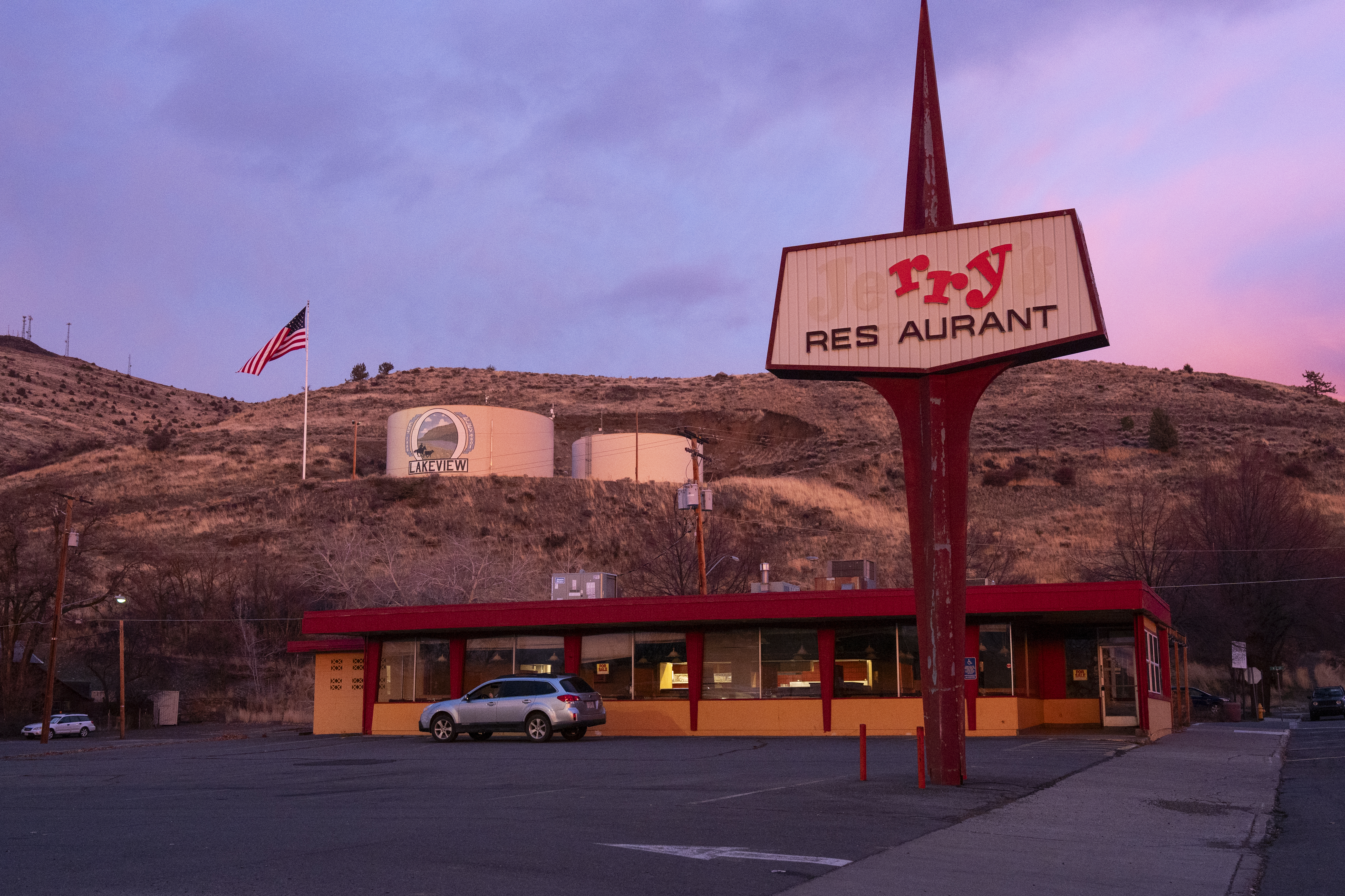 The sun sets over Jerry's restaurant, in Lakeview, Ore, on Dec. 9 , 2025. The diner closed in 2024 after over 50 years in business, and is one of several buildings up for sale in the town.