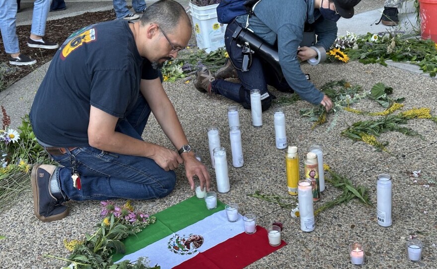 People at the vigil lit candles in honor of Lorenzo Salgado Araujo, and placed bouquets across the plaza.