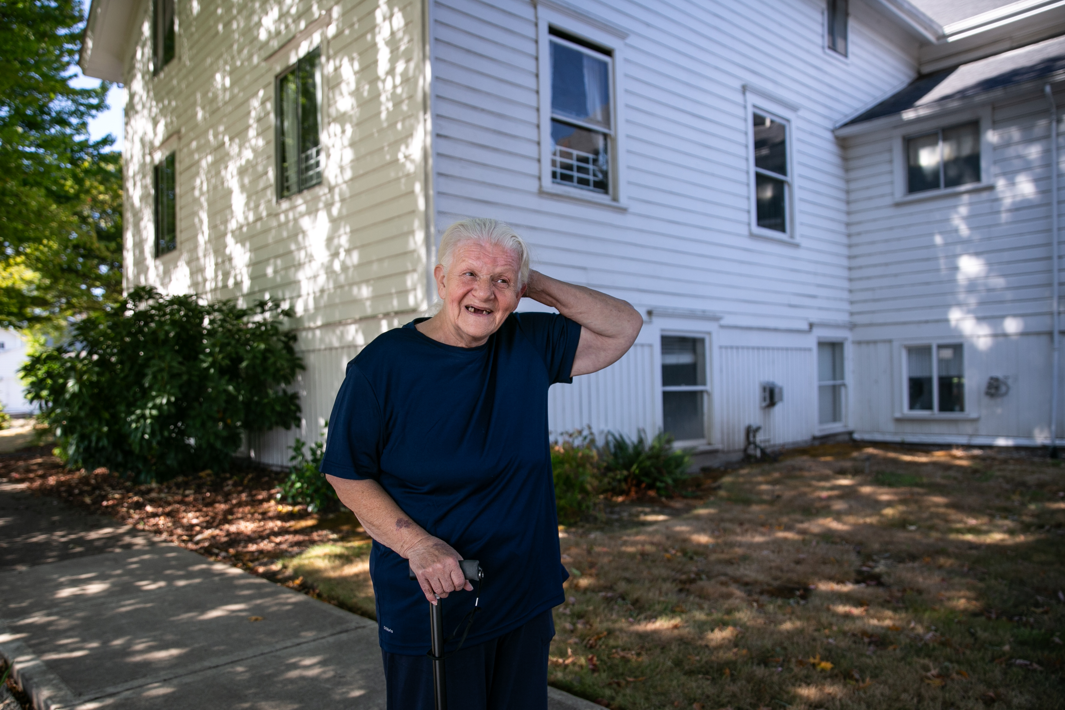 Susan Gallagher poses for a portrait in front of Community Life Church in Monmouth, Ore. on Friday, Sept. 19, 2025. Gallagher, 69, has been a regular at the Safe Showers program hosted by the church since she became homeless.