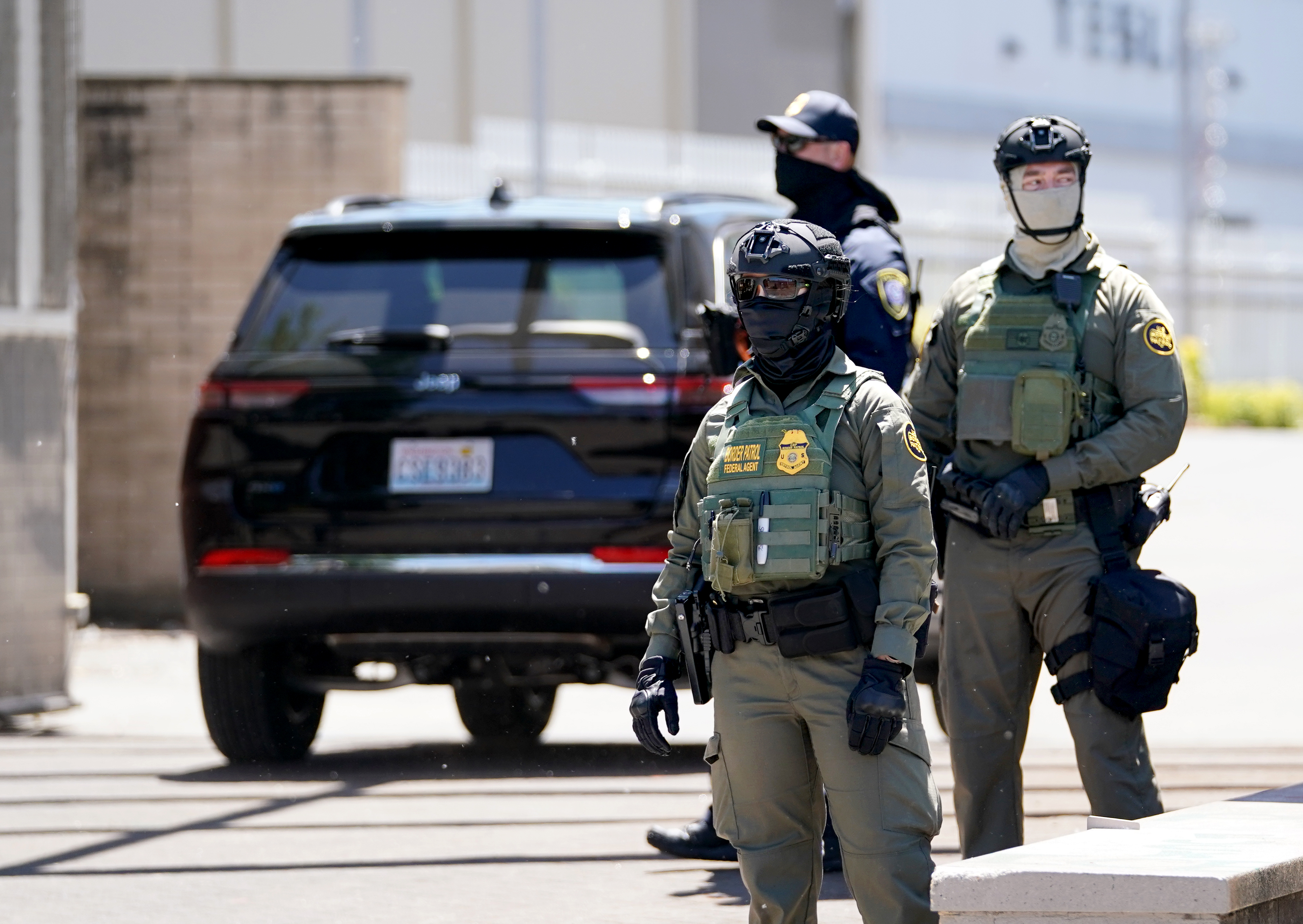 Department of Homeland Security officers protect the driveway of the U.S. Immigration and Customs Enforcement building in Portland, Ore., June 17, 2025. 