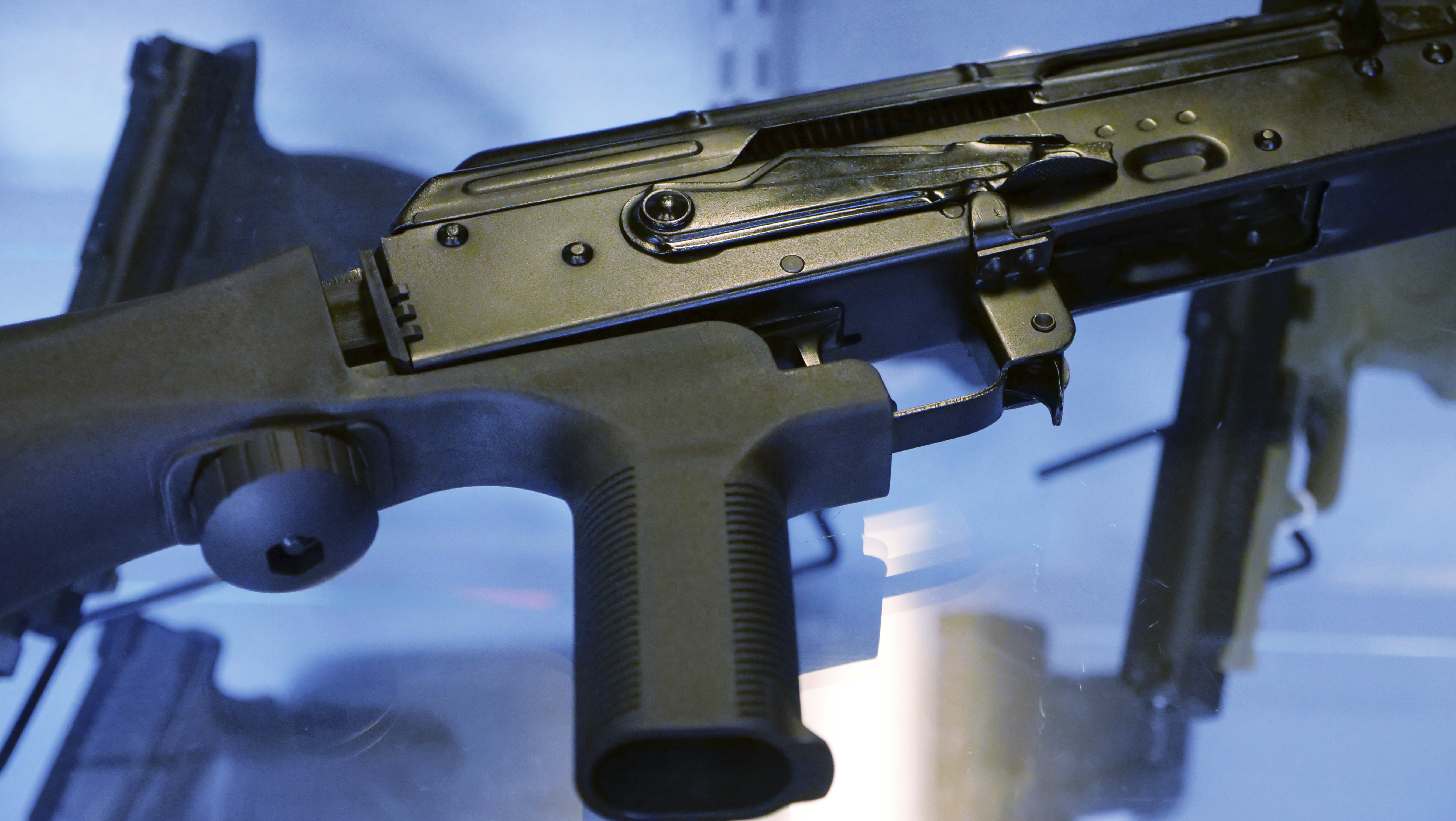 FILE - A bump stock is attached to a semi-automatic rifle at the Gun Vault in South Jordan, Utah, Oct. 4, 2017.