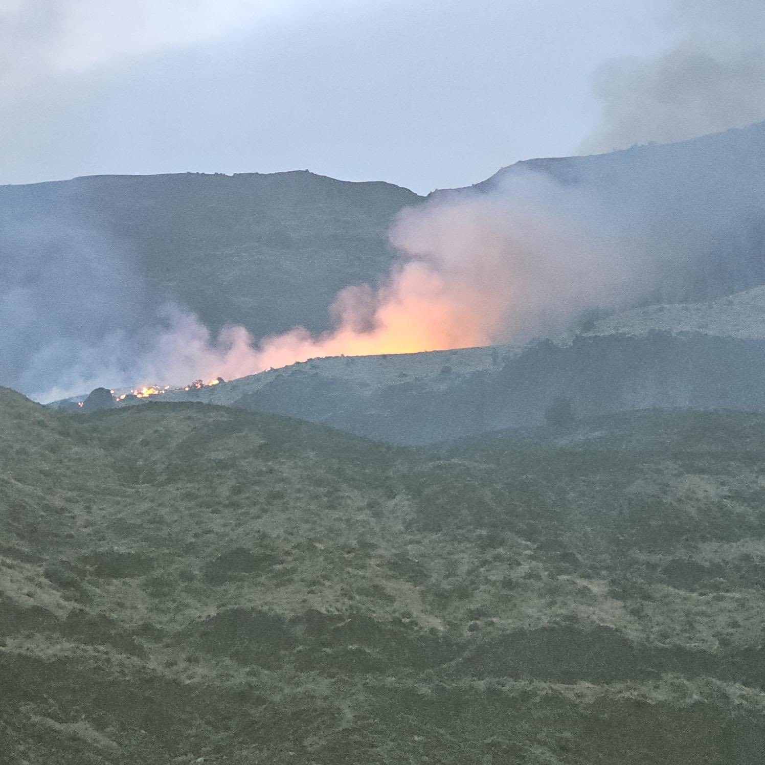 In this photo provided by Wheeler County Fire & Rescue, the Butte Creek Fire burns on a hillside near Clarno, Ore. The fire was first reported on May 25, 2025.