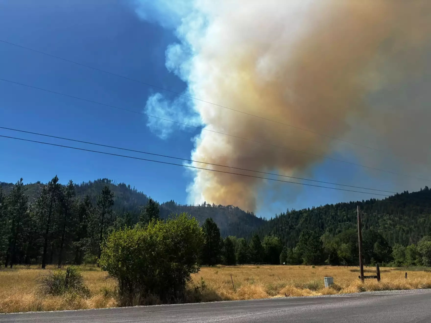 Smoke rises from the Evans Creek Road Fire northeast of Rogue River on Friday, July 10, 2026.