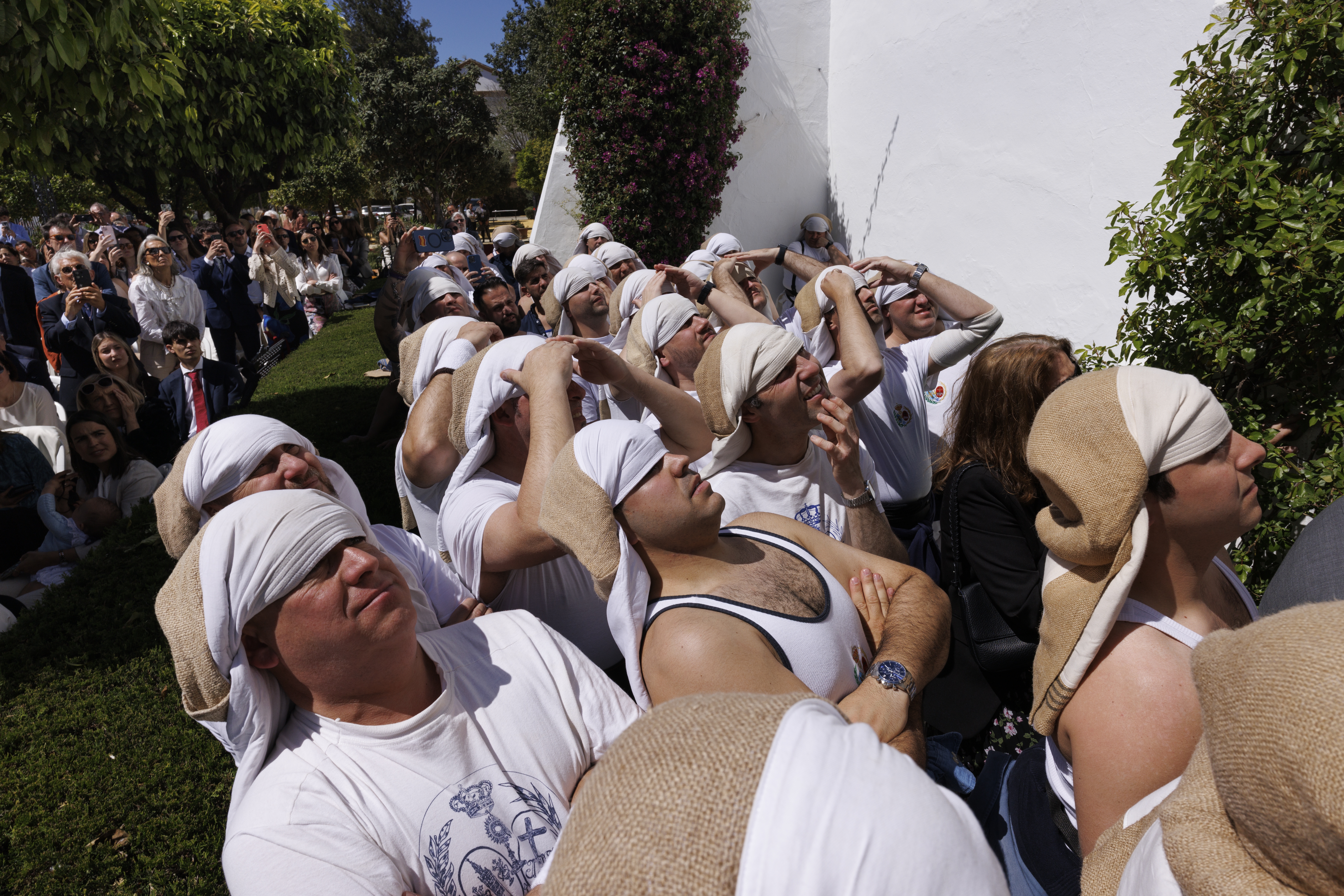 Costaleros (men who carry floats bearing the statue of Christ or the Virgin) of La Paz brotherhood wait before taking part in a procession during Holy Week (Semana Santa) observances on March 29, 2026 in Seville, Spain.