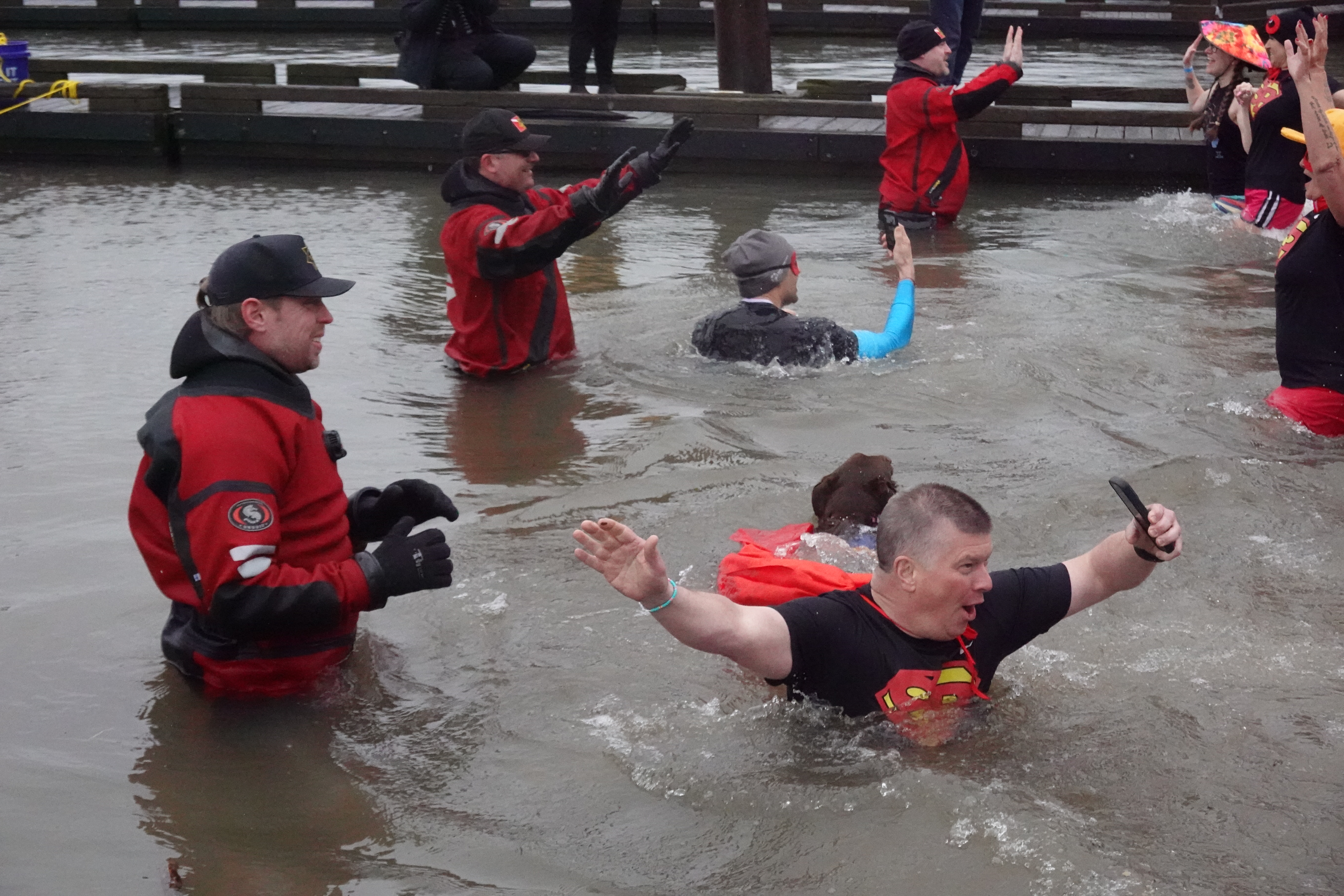 People wade in the frigid Willamette River for the annual Polar Plunge, which raises money for Special Olympics Oregon, on Feb. 21, 2026, in Portland, Ore.