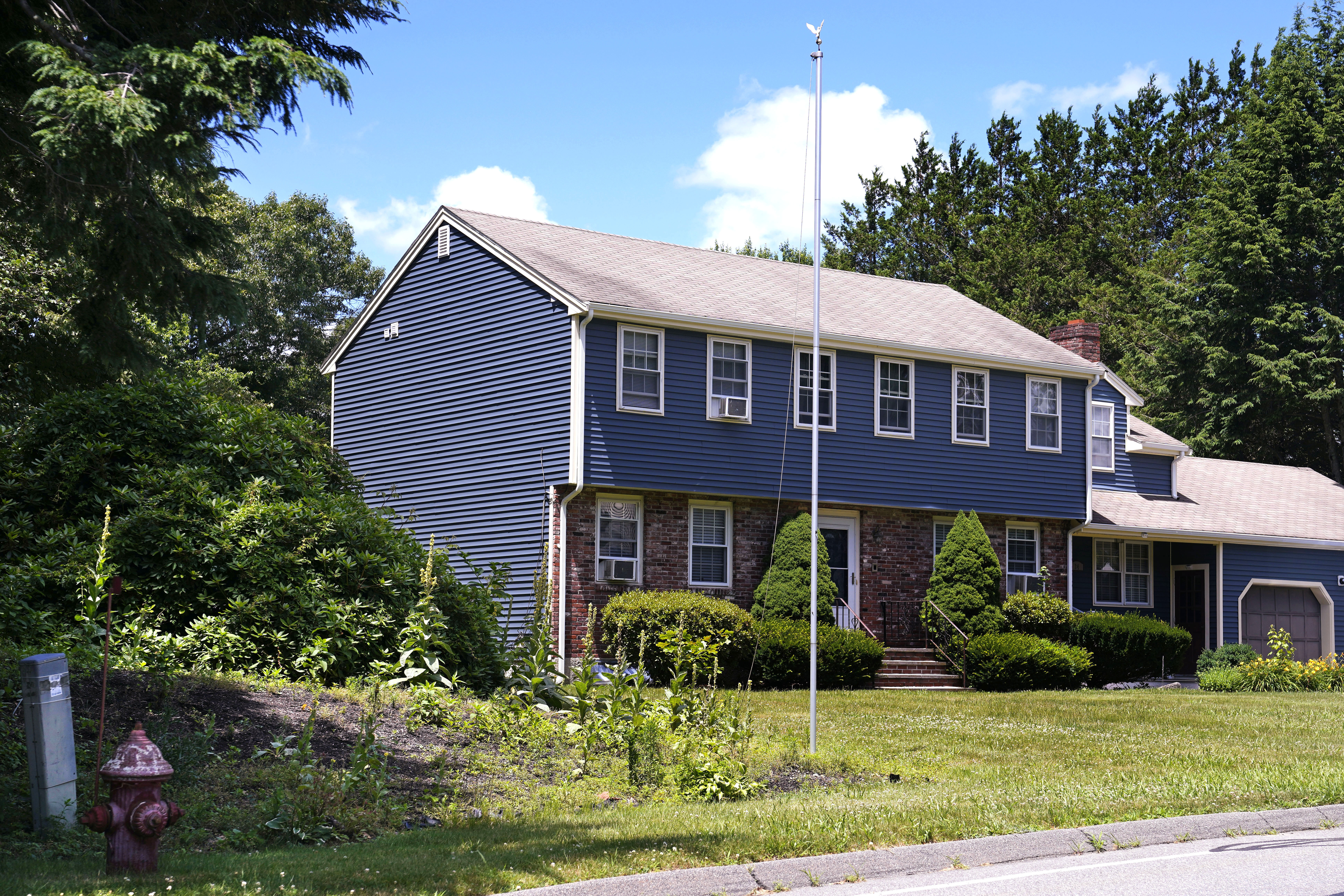 FILE - An empty flagpole is seen outside the residence where the body of John O'Keefe, a Boston police officer, was found on Jan. 29, 2022, outside the home, Thursday, June 27, 2024, in Canton, Mass. A judge declared a mistrial Monday, July 1, 2024, after jurors deadlocked in the case of Karen Read, who was accused of killing her boyfriend, O'Keefe, by striking him with her SUV and leaving him in a snowstorm. Prosecutors said in a statement that they intend to retry the case.