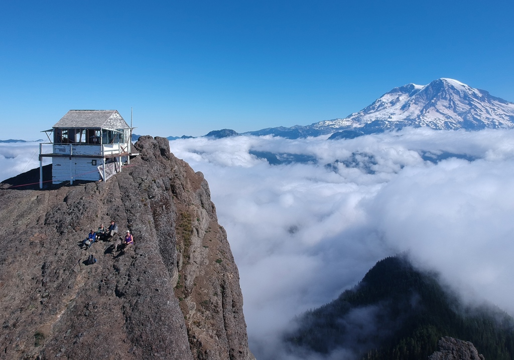 Historic High Rock Lookout, shown here in an aerial drone photo taken by Mary Prophit in 2018, is perched on a 5,685-foot peak, offering visitors a spectacular view of Mount Rainier. It is one of the most popular destinations for hikers in the area. 