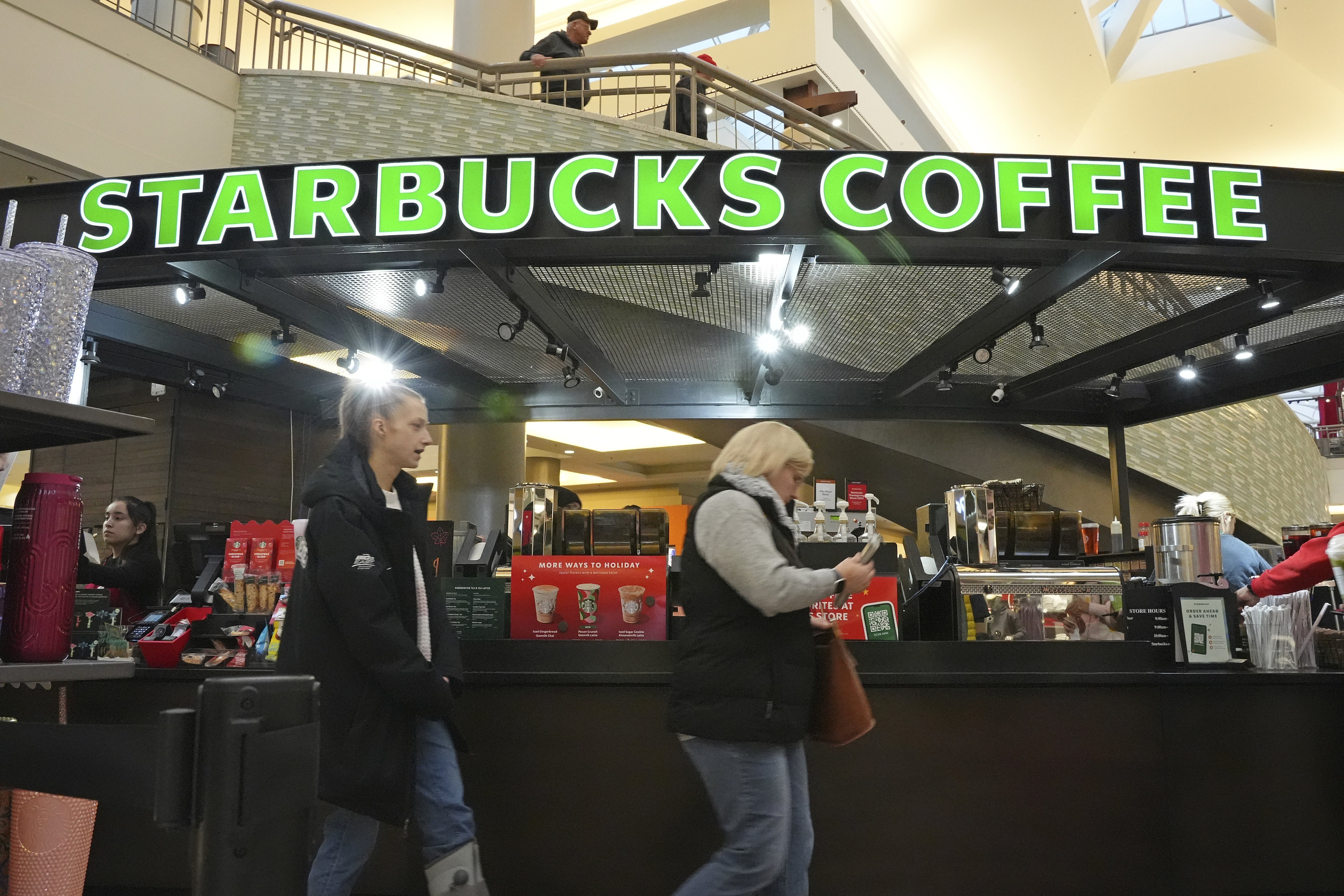 FILE - Shoppers at the Walden Galleria in Buffalo, NY, stop by the Starbucks kiosk on Nov. 30, 2024.