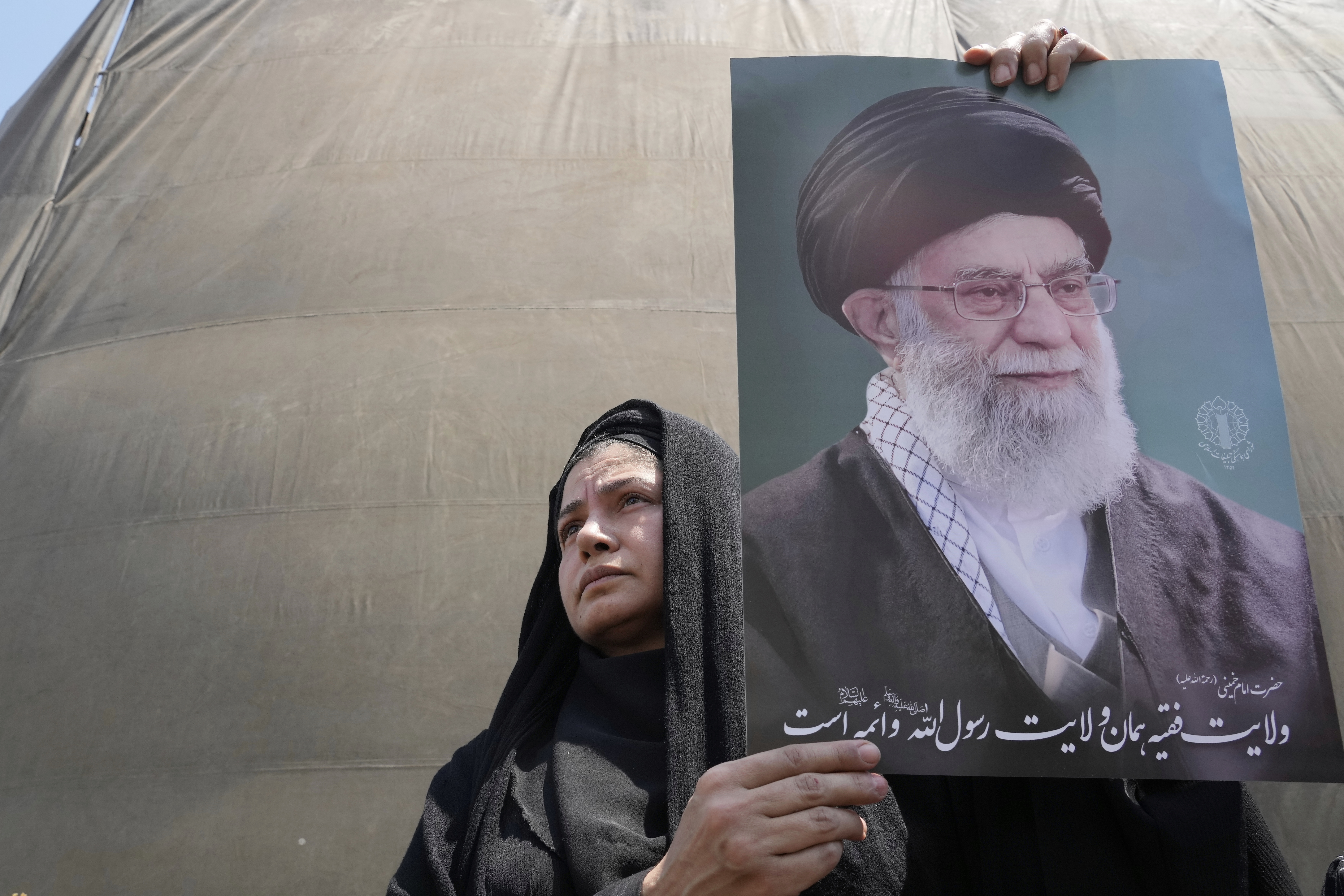 An Iranian protester holds up a poster of the Supreme Leader Ayatollah Ali Khamenei in an anti-Israeli gathering in Tehran, Iran, Friday, June 13, 2025.