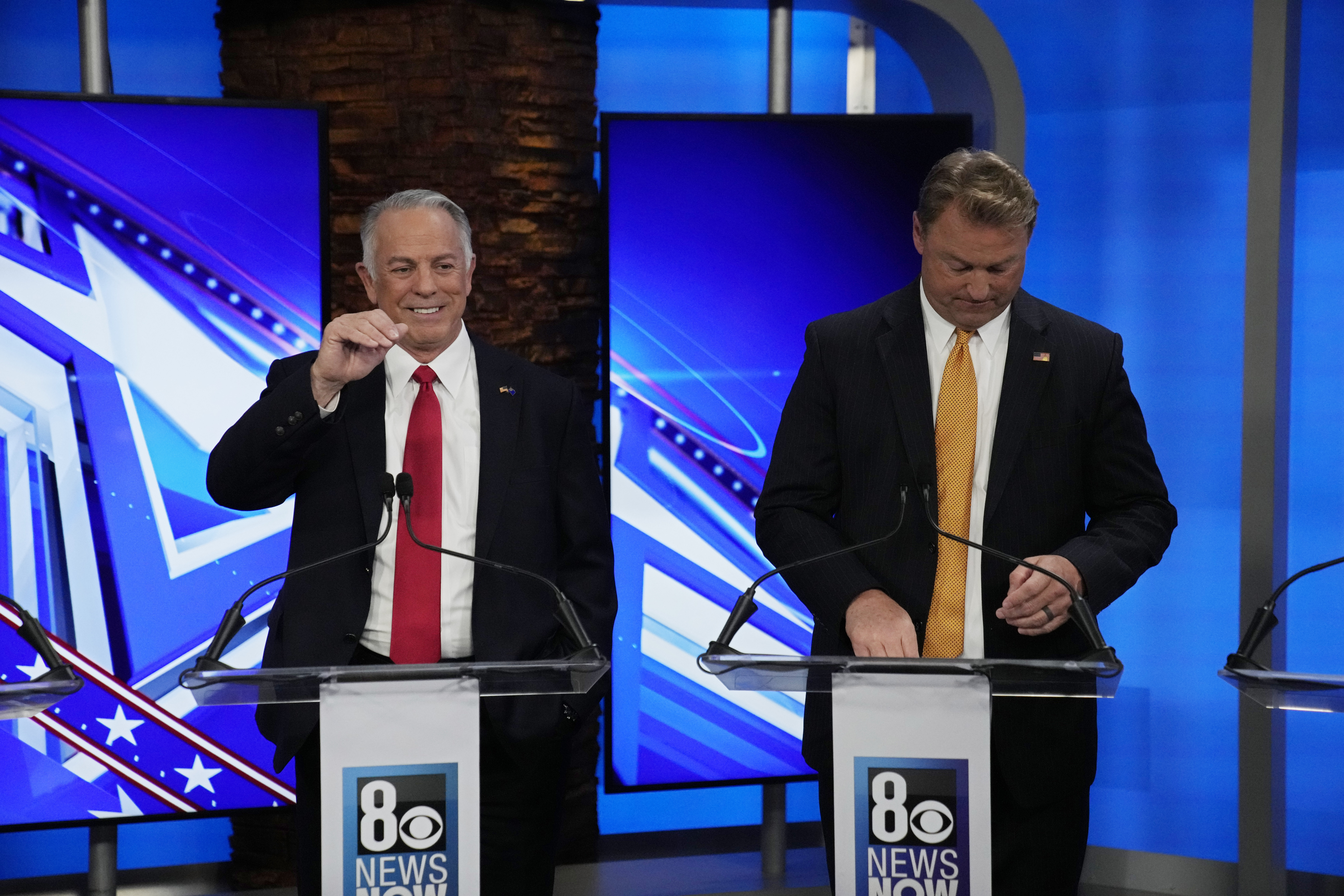 Clark County Sheriff Joe Lombardo, left, motions beside former U.S. Senator Dean Heller laugh before a Republican primary debate for Nevada governor Wednesday, May 25, 2022, in Las Vegas.