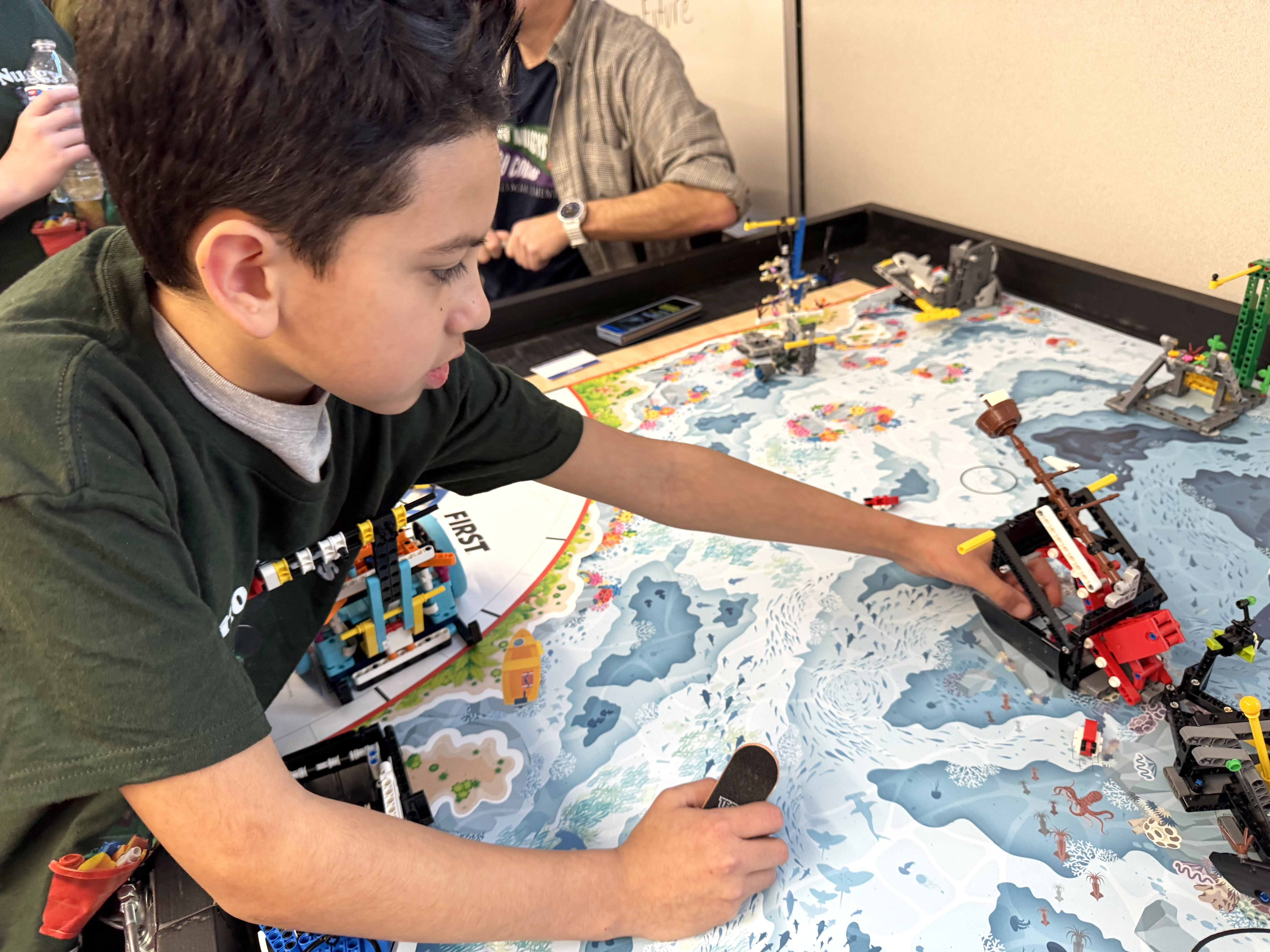 Fourth grader Sergio Preciado shows off a Lego shipwreck he helped build and code with his FIRST Lego League team, called the Dino Nuggys. The program is mostly grant funded through the Washington Office of Superintendent of Public Instruction.