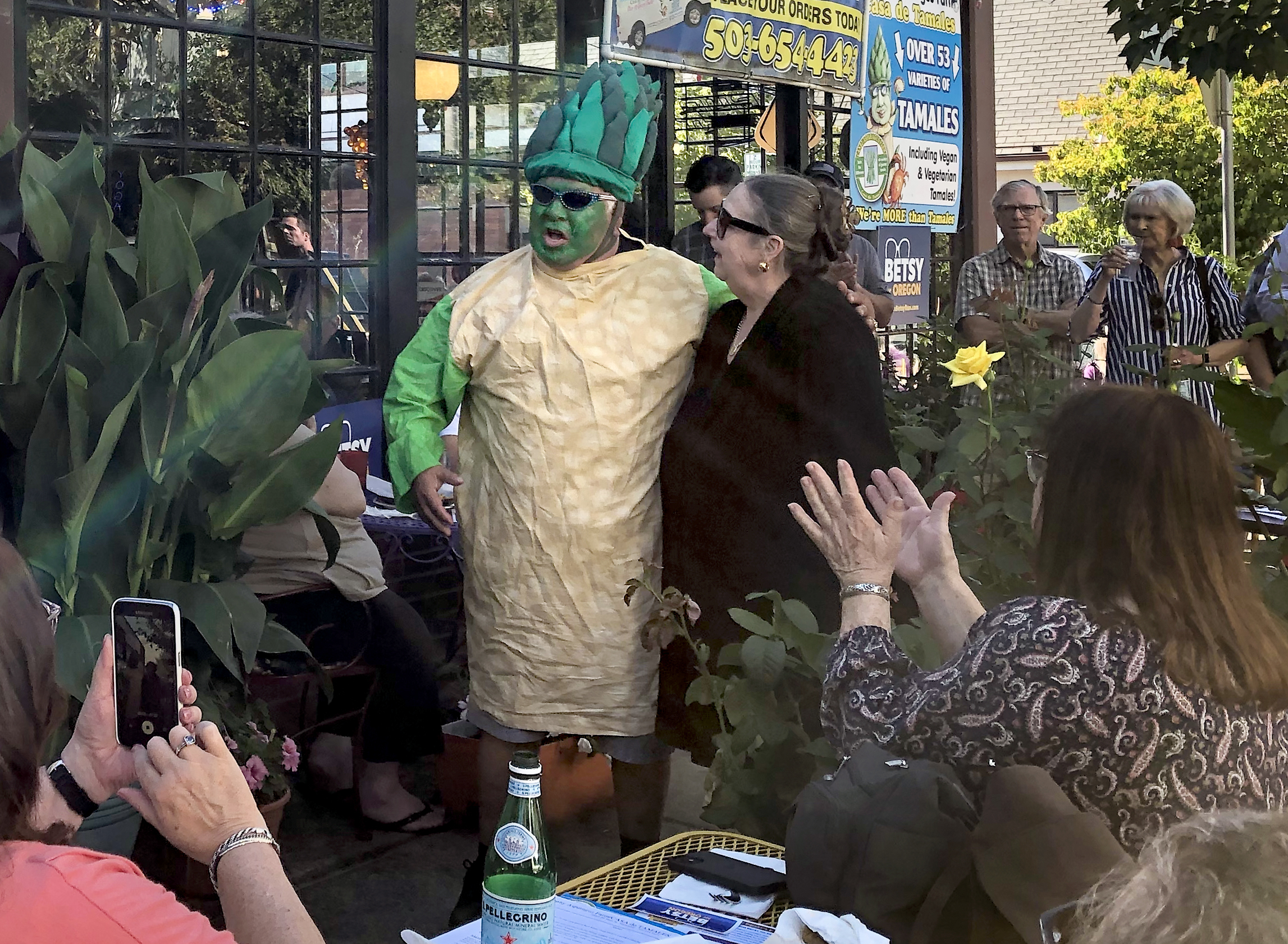 Betsy Johnson poses with Charles Maes, who is dressed like a stalk of asparagus. Maes' Milwaukie restaurant, Casa de Tamales, hosted an event for Johnson on July 7, 2022.