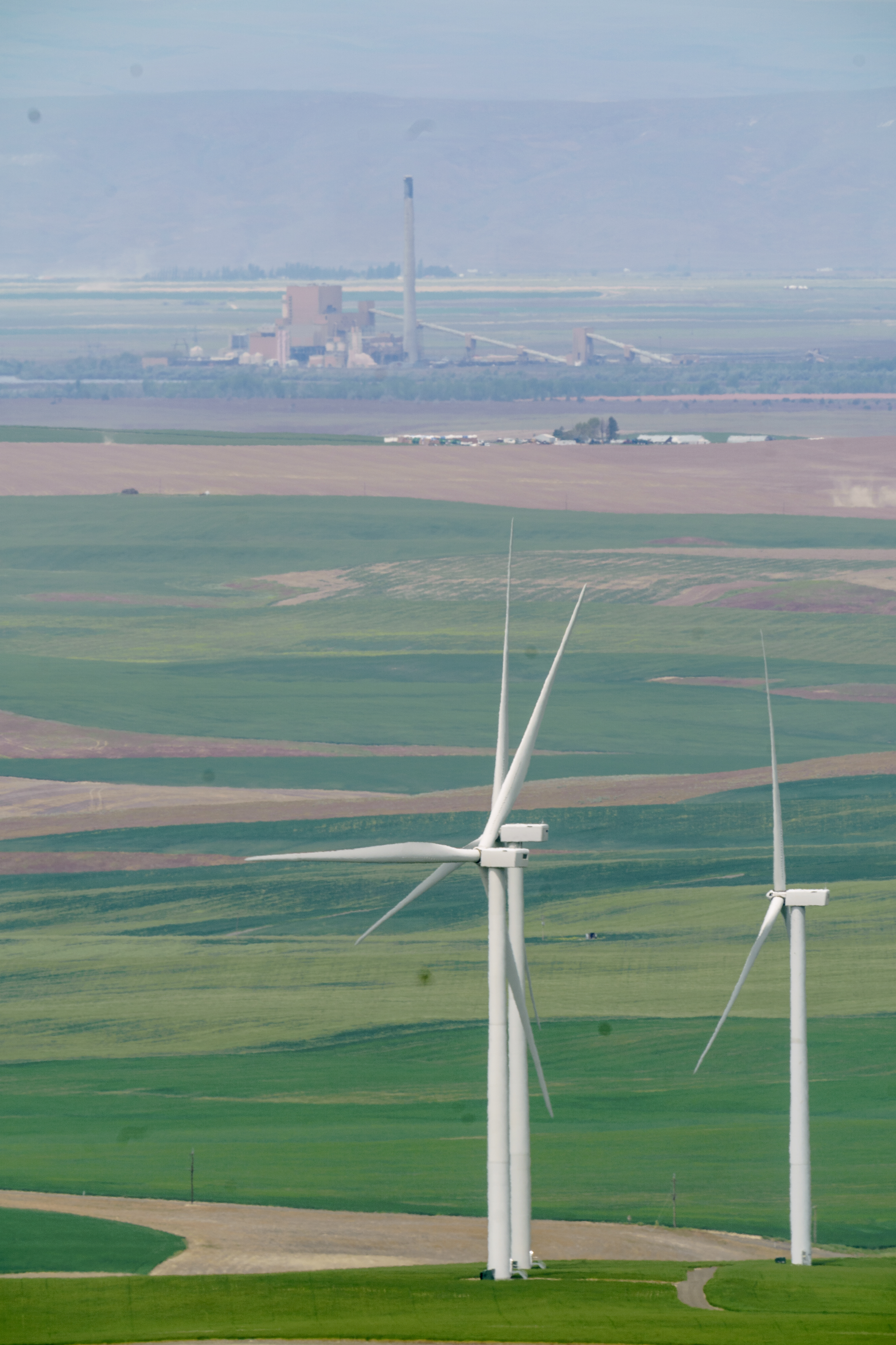 Energy produced by wind turbines and solar panels utilize some of the existing transmission lines from the former Boardman Coal Plant, top left.