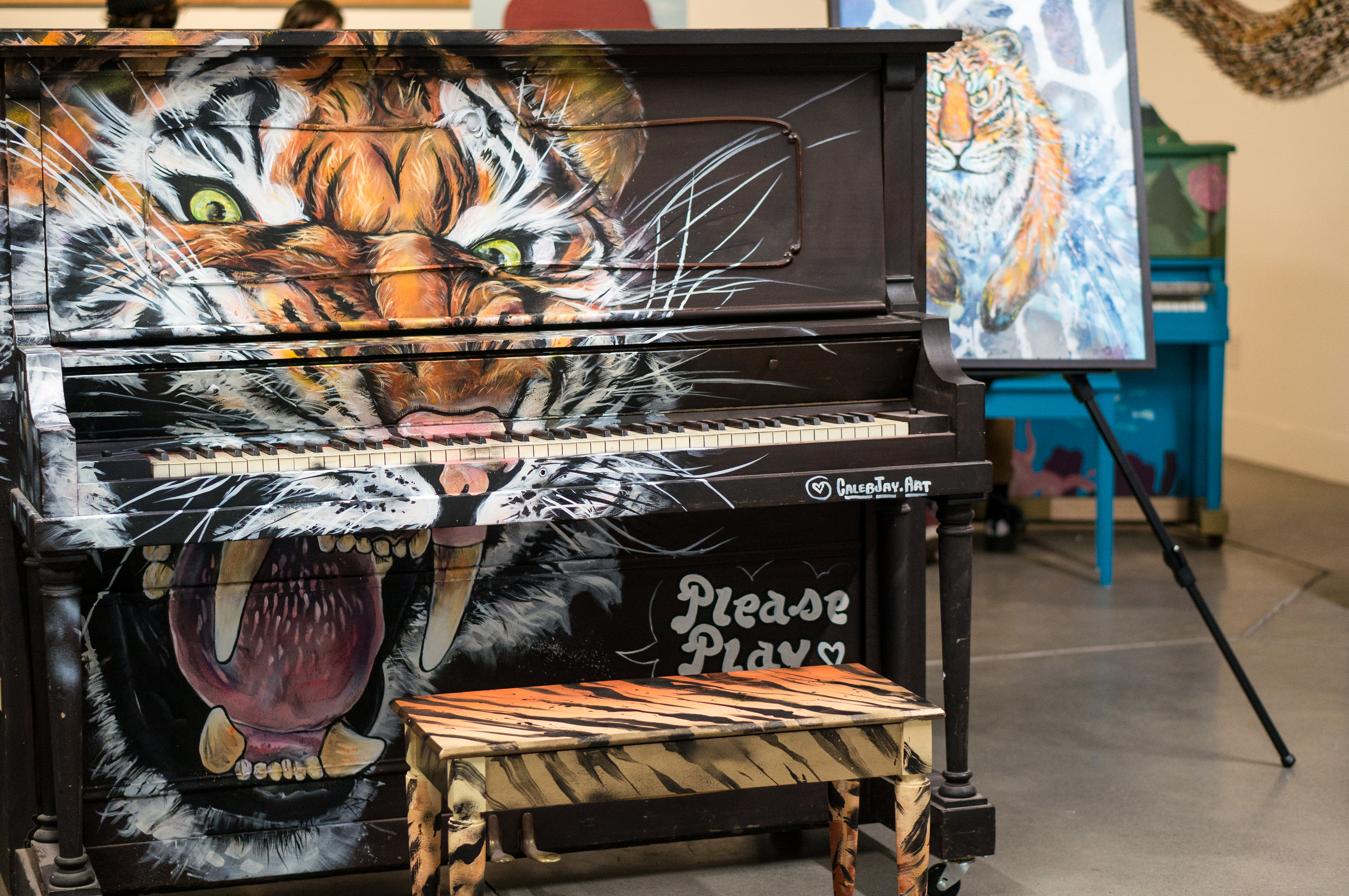 A tiger-themed piano made by artist Caleb Jay for Piano. Push. Play.