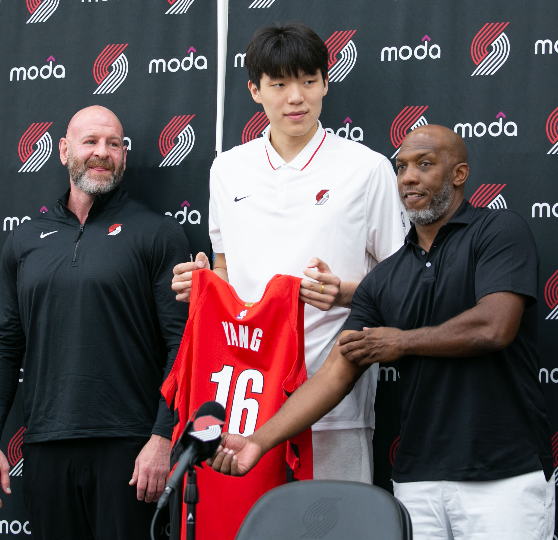 (Left to right) Trail Blazers General Manager Joe Cronin, stands with the team's NBA Draft pick Yang Hansen and Trail Blazers Head Coach Chauncey Billups, during a press conference at the Trail Blazers Practice Facility in Portland, Ore., June 27, 2025. The Blazer's pick of Yang came as a surprise to many NBA fans, despite it being a few years in the making according to the team’s coaches.