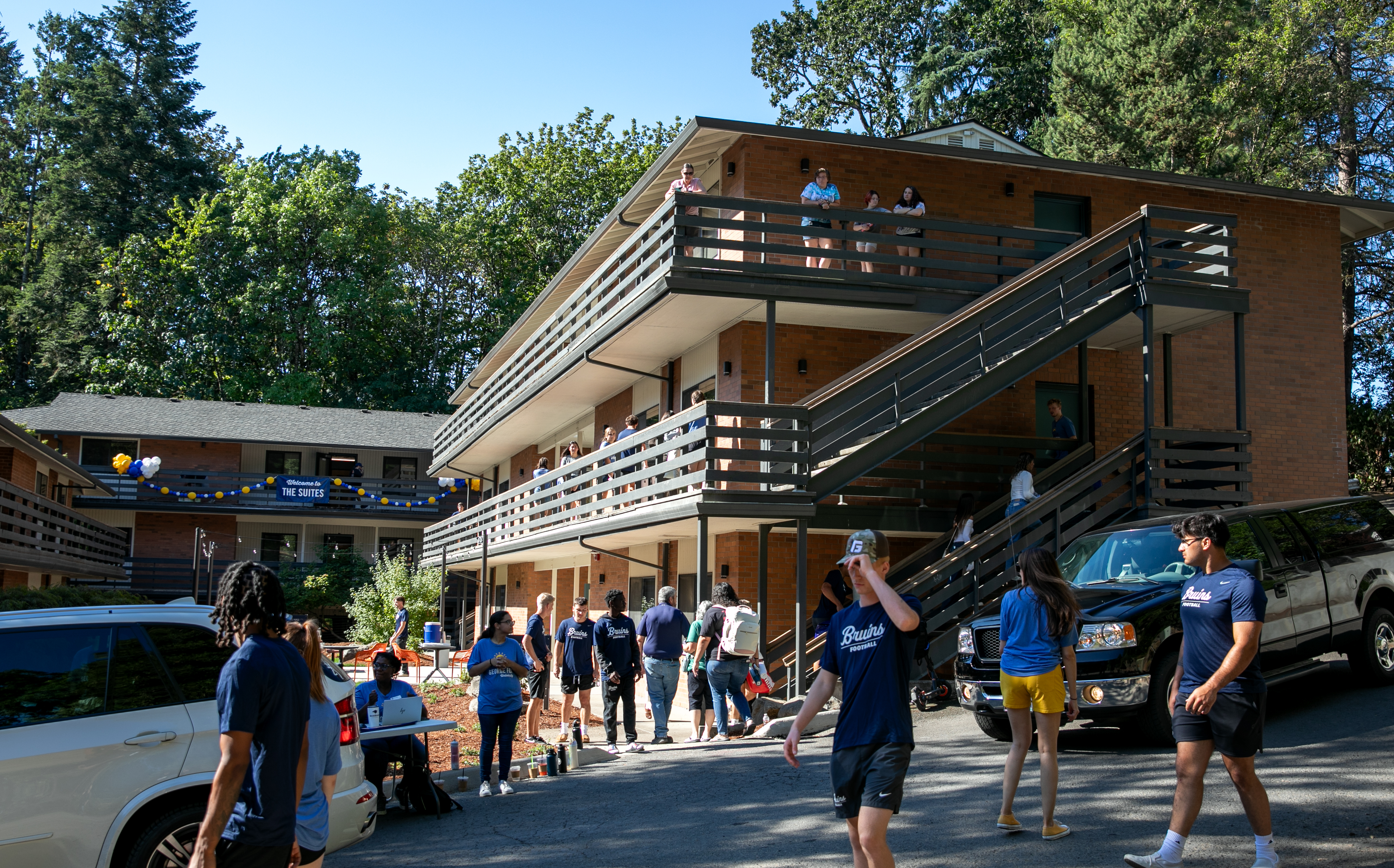 Student and faculty volunteers help students move into their dorms.
