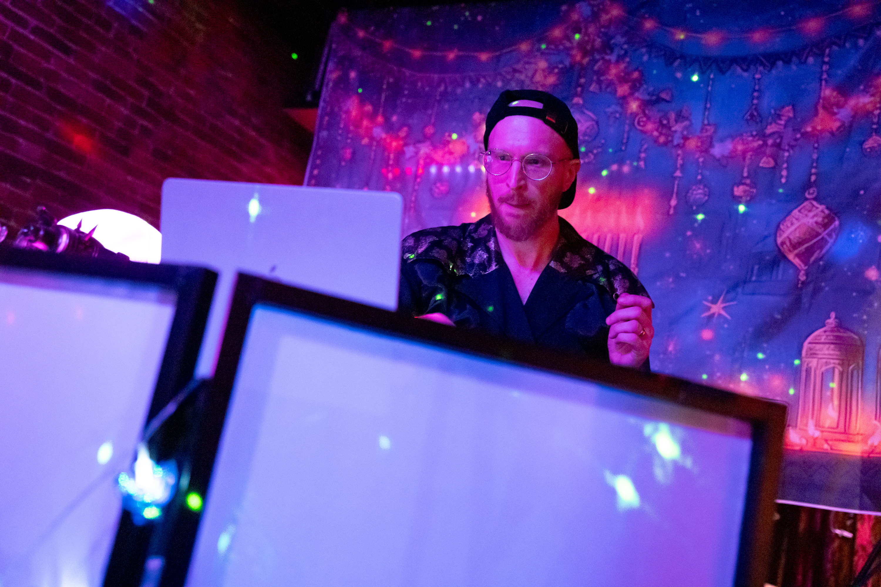 Yosef Rosen, known as DJ Bambi, plays tracks at a Hanukkah rave, the night before the first evening of the Jewish holiday, at the Barrel Room in Portland, Ore., on Dec. 13, 2025.