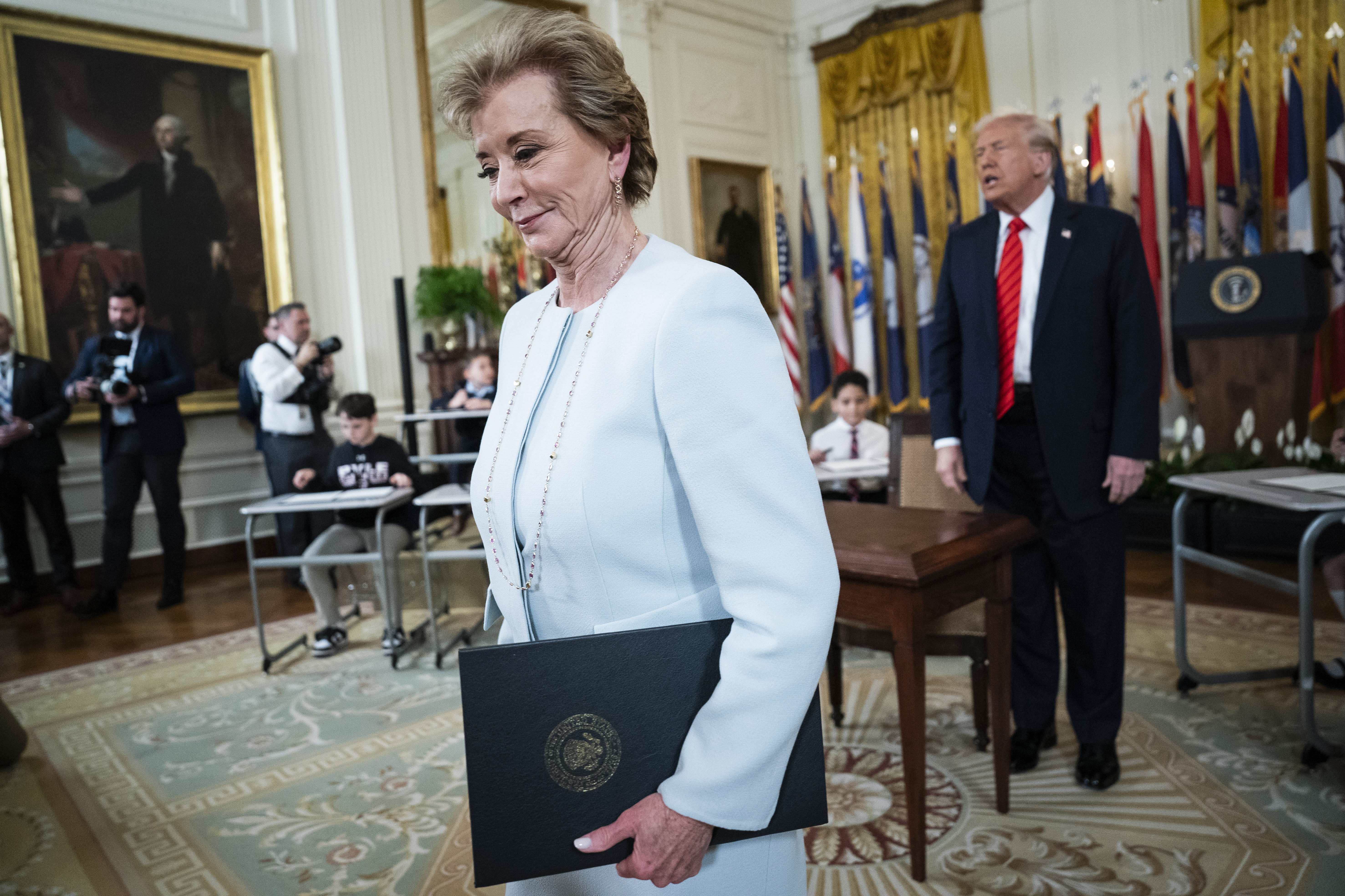 Secretary of Education Linda McMahon and President Donald Trump depart after the president signed an executive order, on March 20, aimed at closing the Education Department.