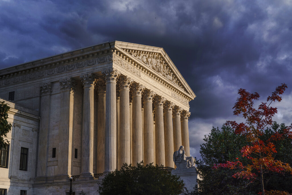 Classical stone columns of a government building, with sky in the background.