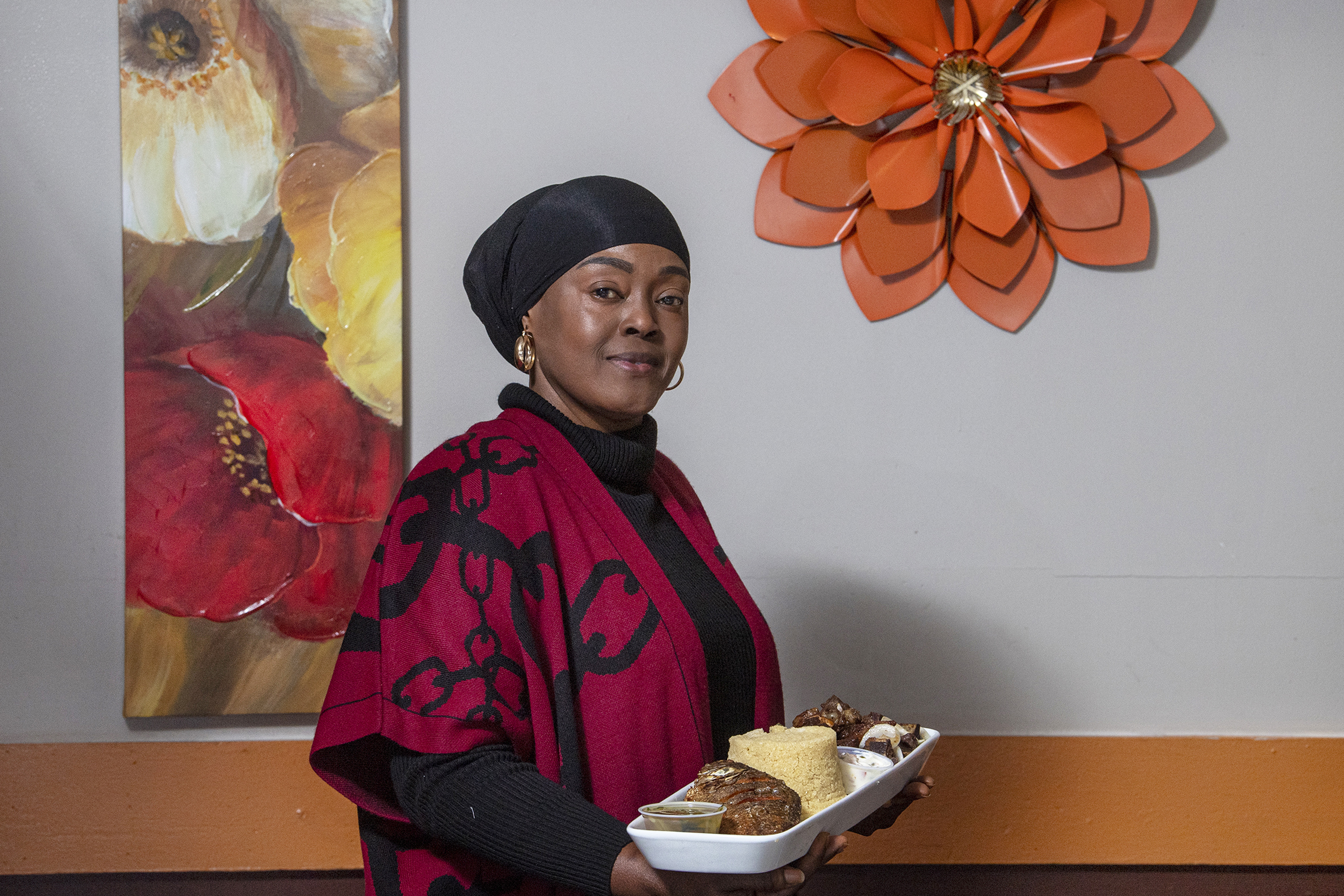 Fanta Fofana - co-owner and chef, holds a cassava couscous dish at her restaurant, Le Mandingue . on Woodland Ave, in Philadelphia, Pa.