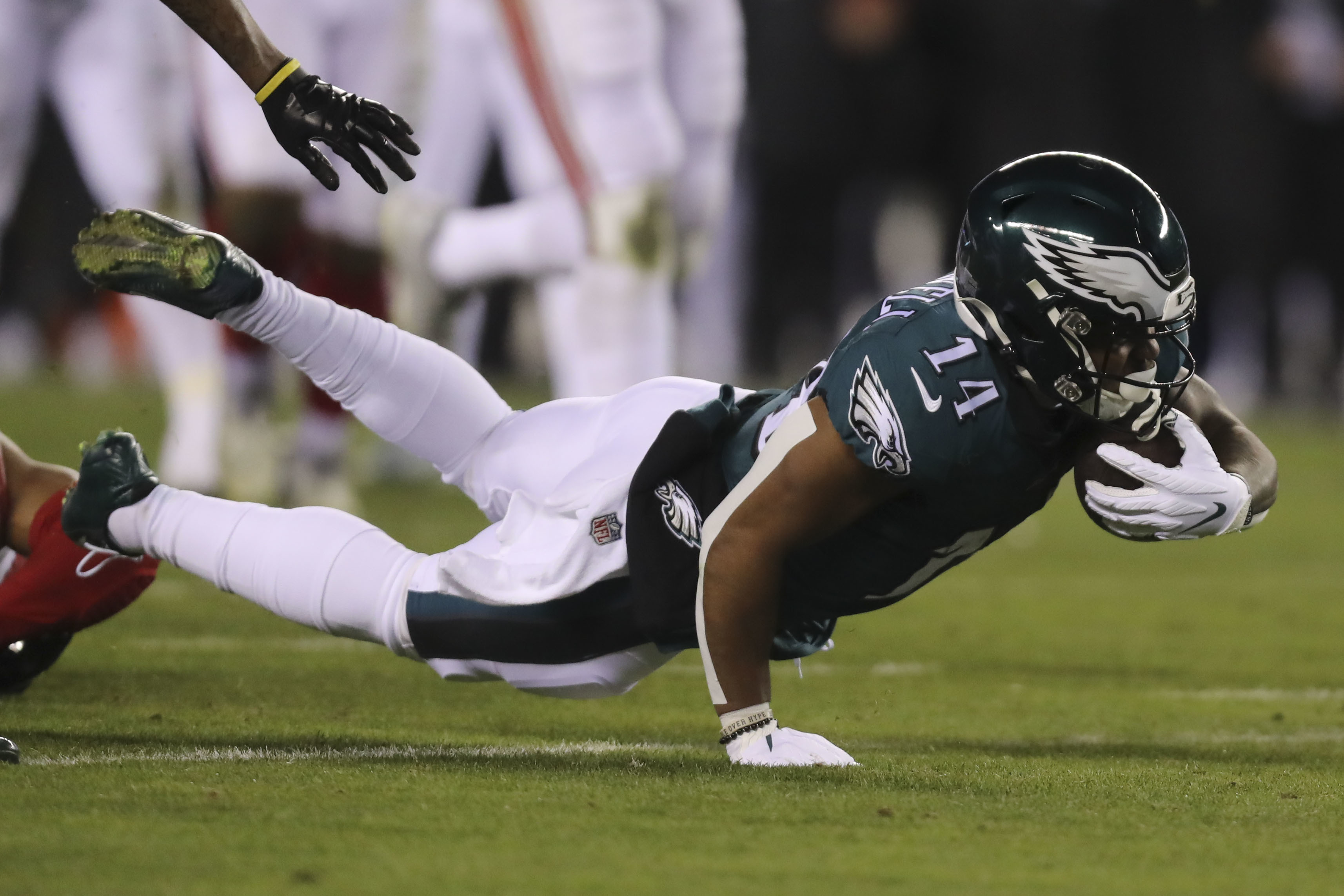 January 21, 2023, Philadelphia, PA, USA: January 21, 2023: Philadelphia  Eagles running back Kenneth Gainwell (14) tries to break free for extra  yardage during a run during the NFL football playoff matchup