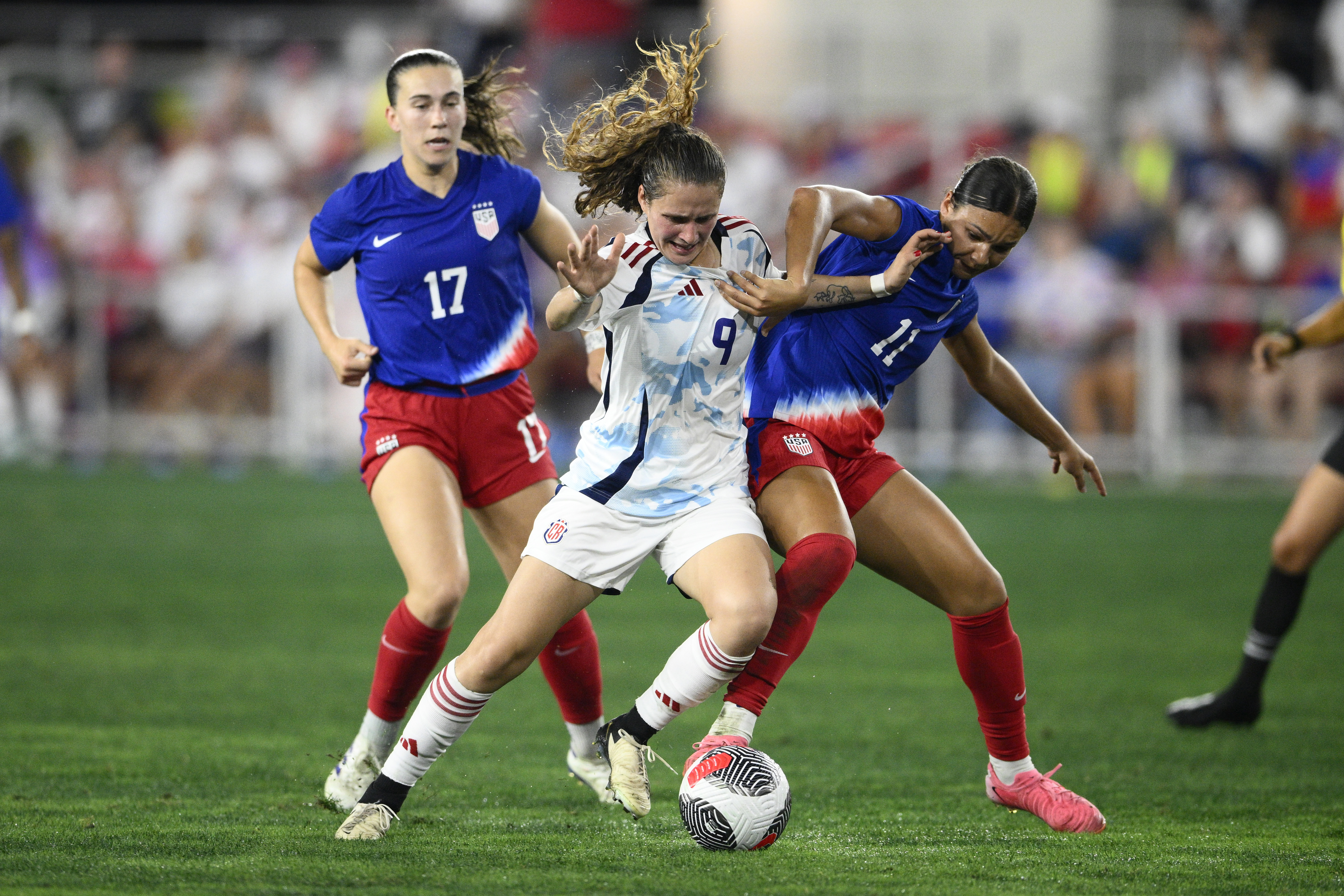 Sophia Smith (right) battles for the ball as Sam Coffey looks on during the second half of the U.S. women's soccer team's scoreless tie with Costa Rica on Tuesday, its last game before the Olympics.