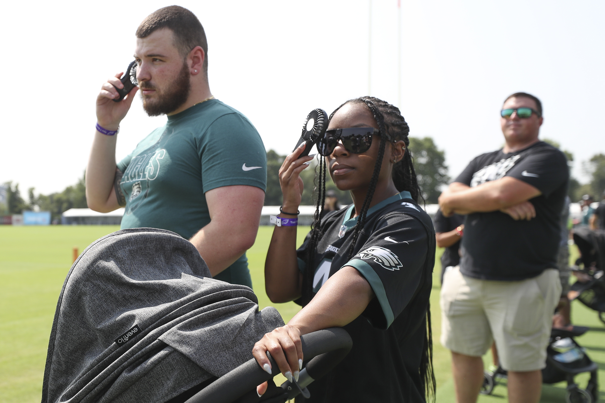 Philadelphia Eagles' Jalen Hurts, left, signs a jersey for a member of the  military's family during practice at NFL football team's training camp,  Saturday, July 30, 2022, in Philadelphia. (AP Photo/Chris Szagola