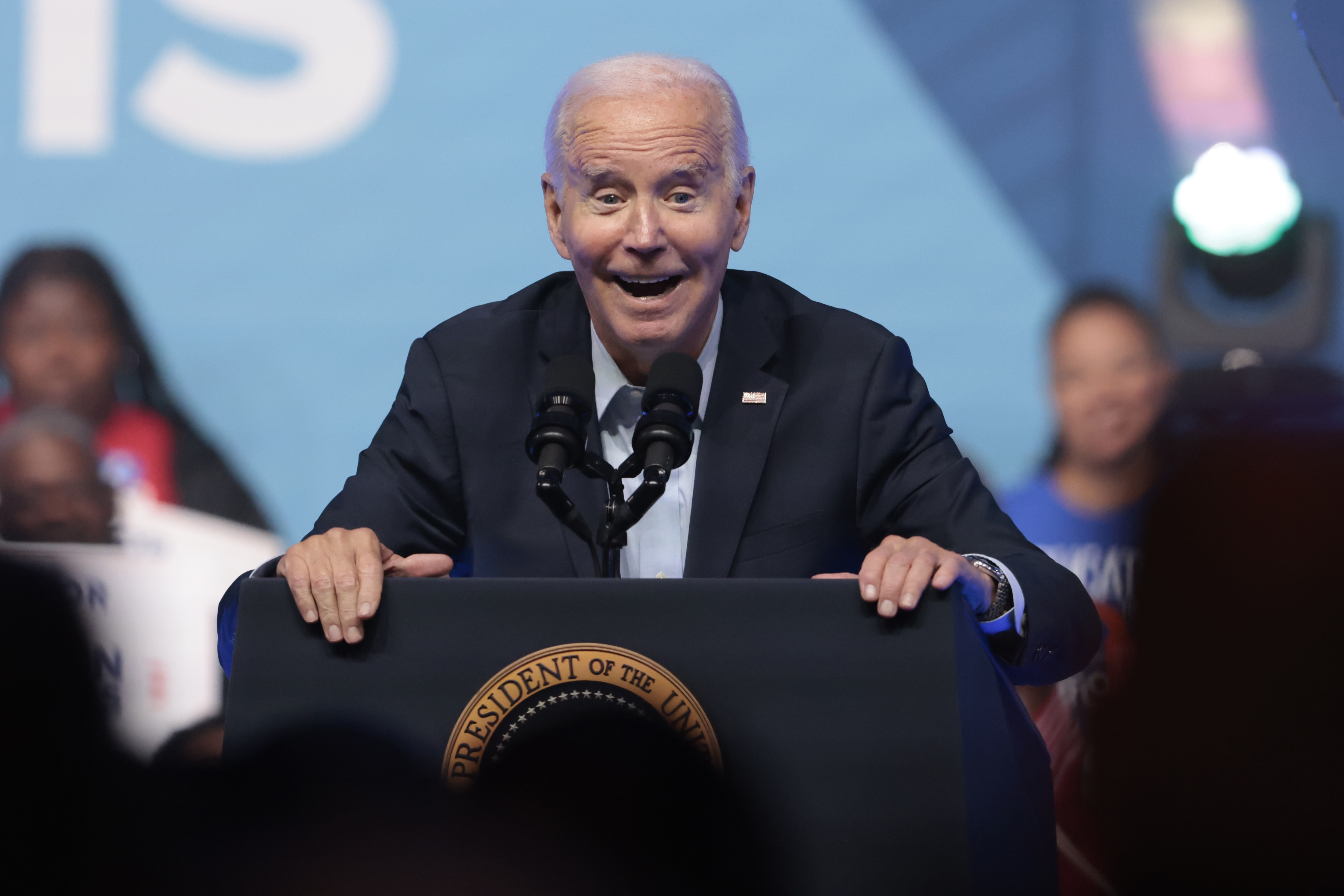 U.S. President Joe Biden holds up a jersey presented to him by